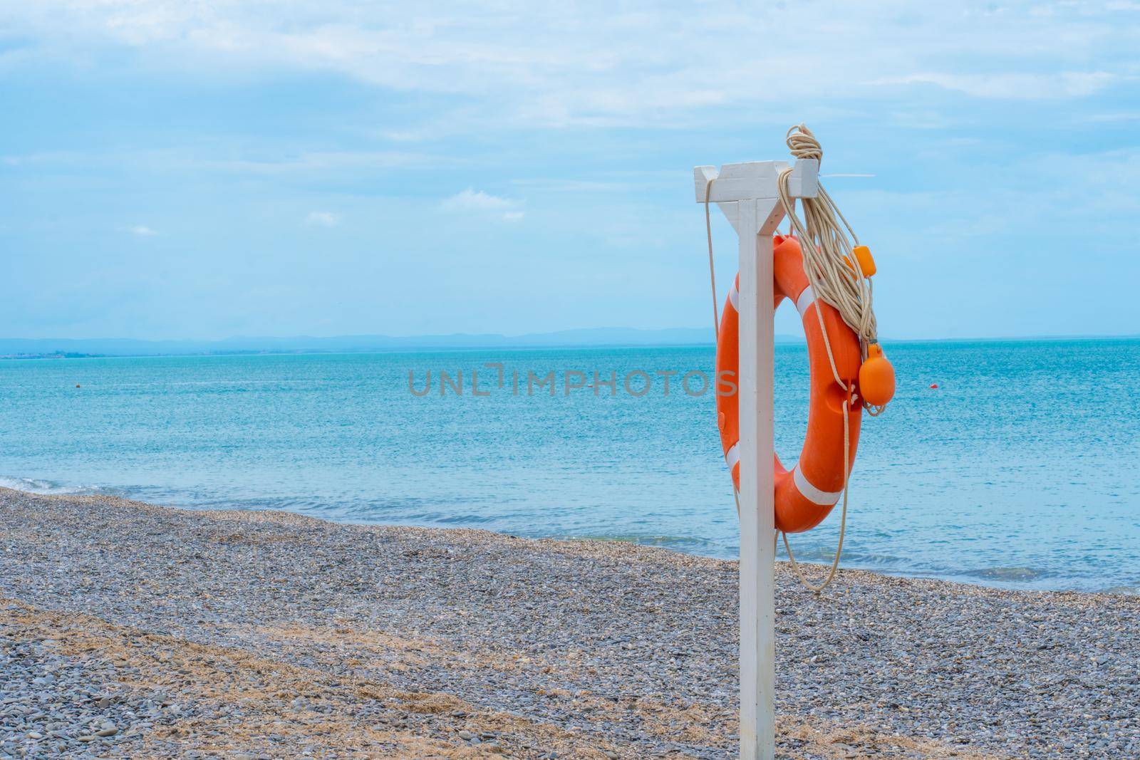 Life ring beach sea buoy orange closeup saving rescue round, concept red guard from emergency from ocean assistance, shore safe. Survival background calm, by 89167702191