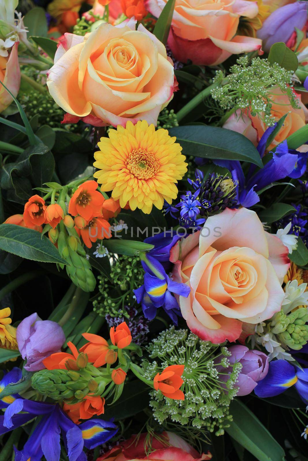 Mixed flower arrangement: various flowers in different colors for a wedding by studioportosabbia