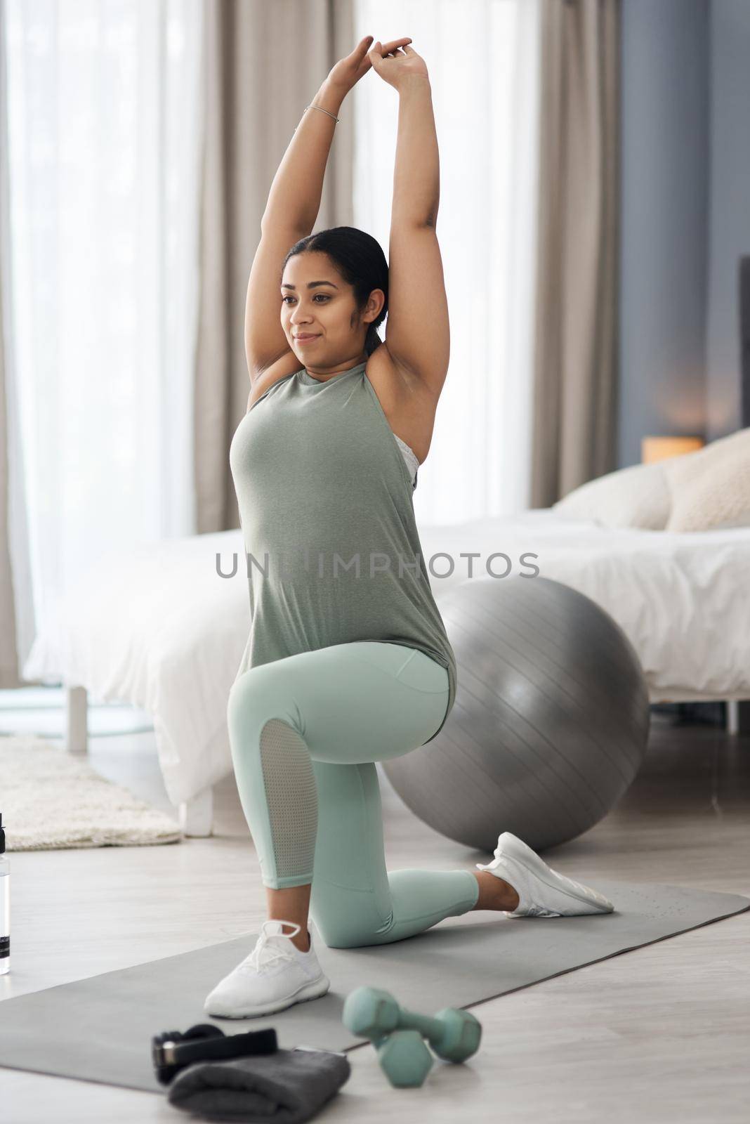 A little progress each day all adds up. a sporty young woman exercising at home