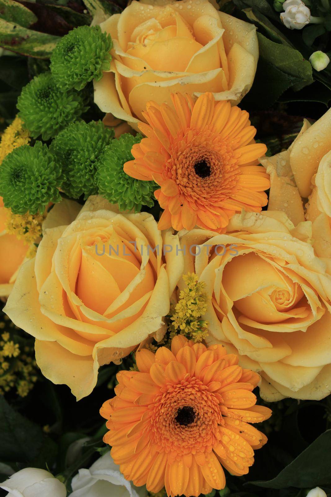 Yellow wedding roses in a floral wedding decoration with some gerbers by studioportosabbia