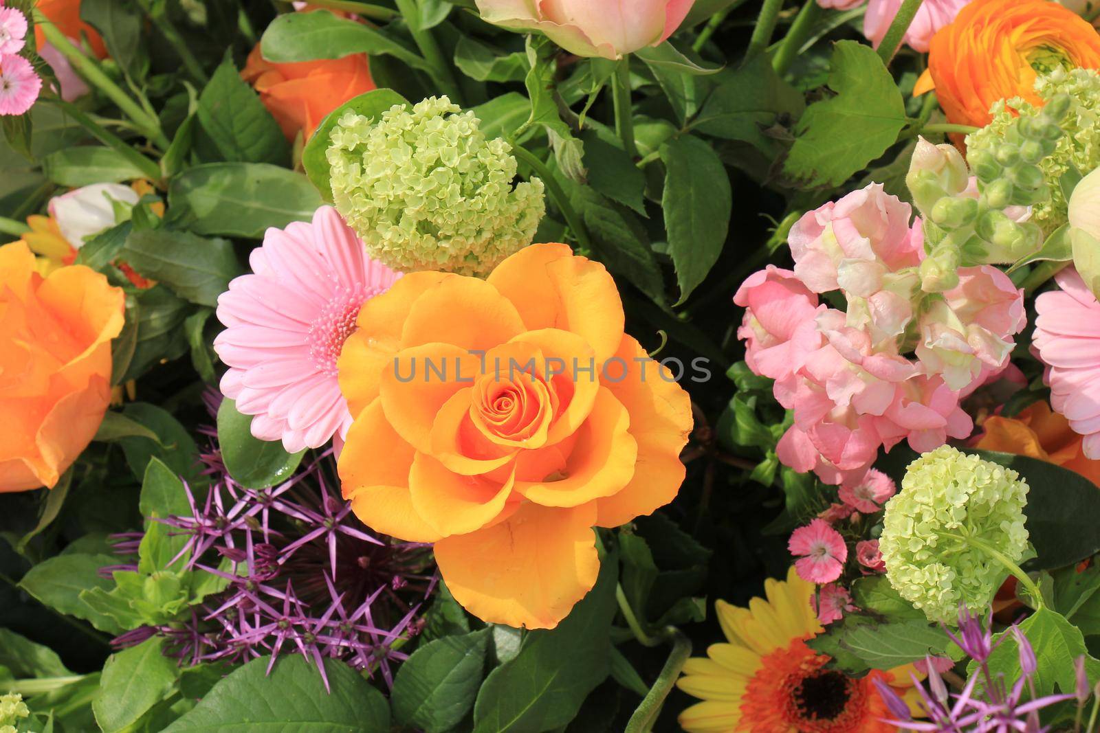 Mixed flower arrangement: various flowers in different shades of pink and orange for a wedding