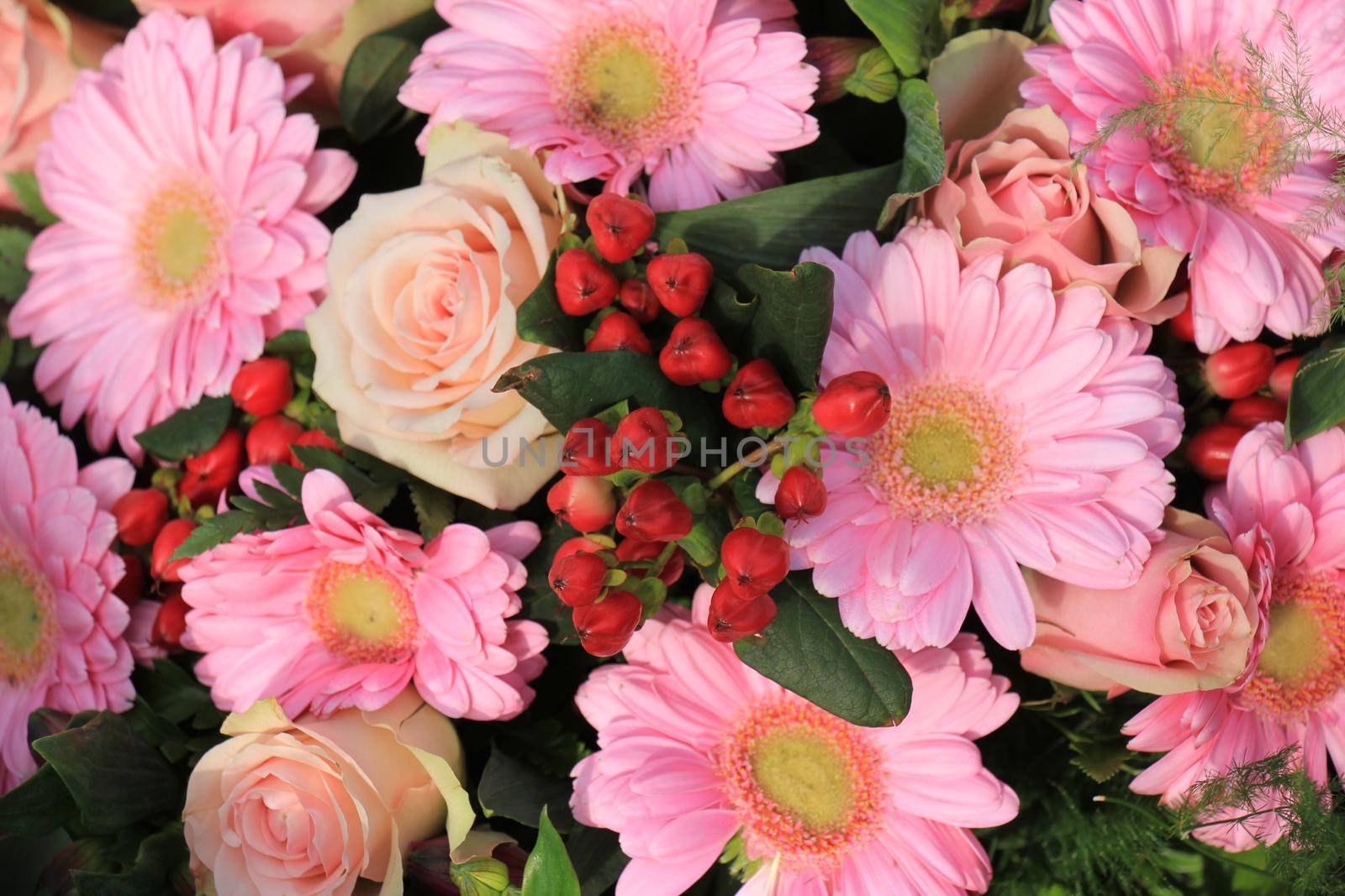 Mixed pink flowers in a floral wedding decoration by studioportosabbia