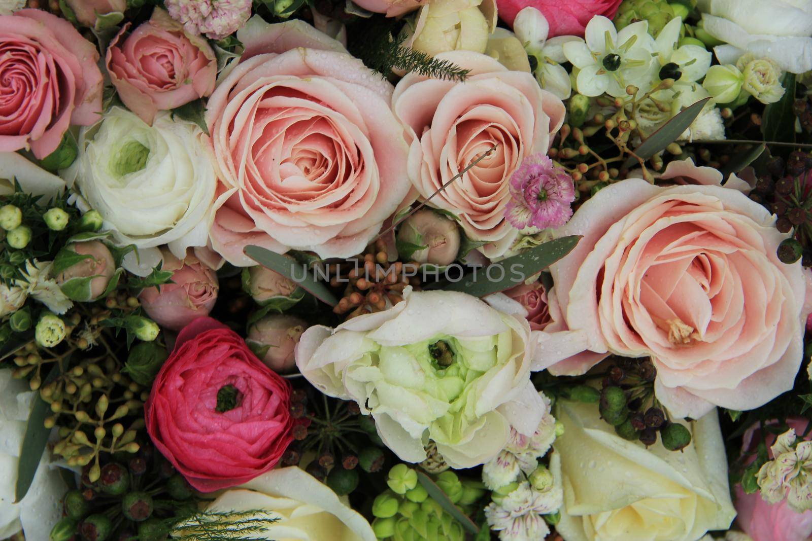 Mixed wedding flower arrangement: various flowers in different pastel colors by studioportosabbia