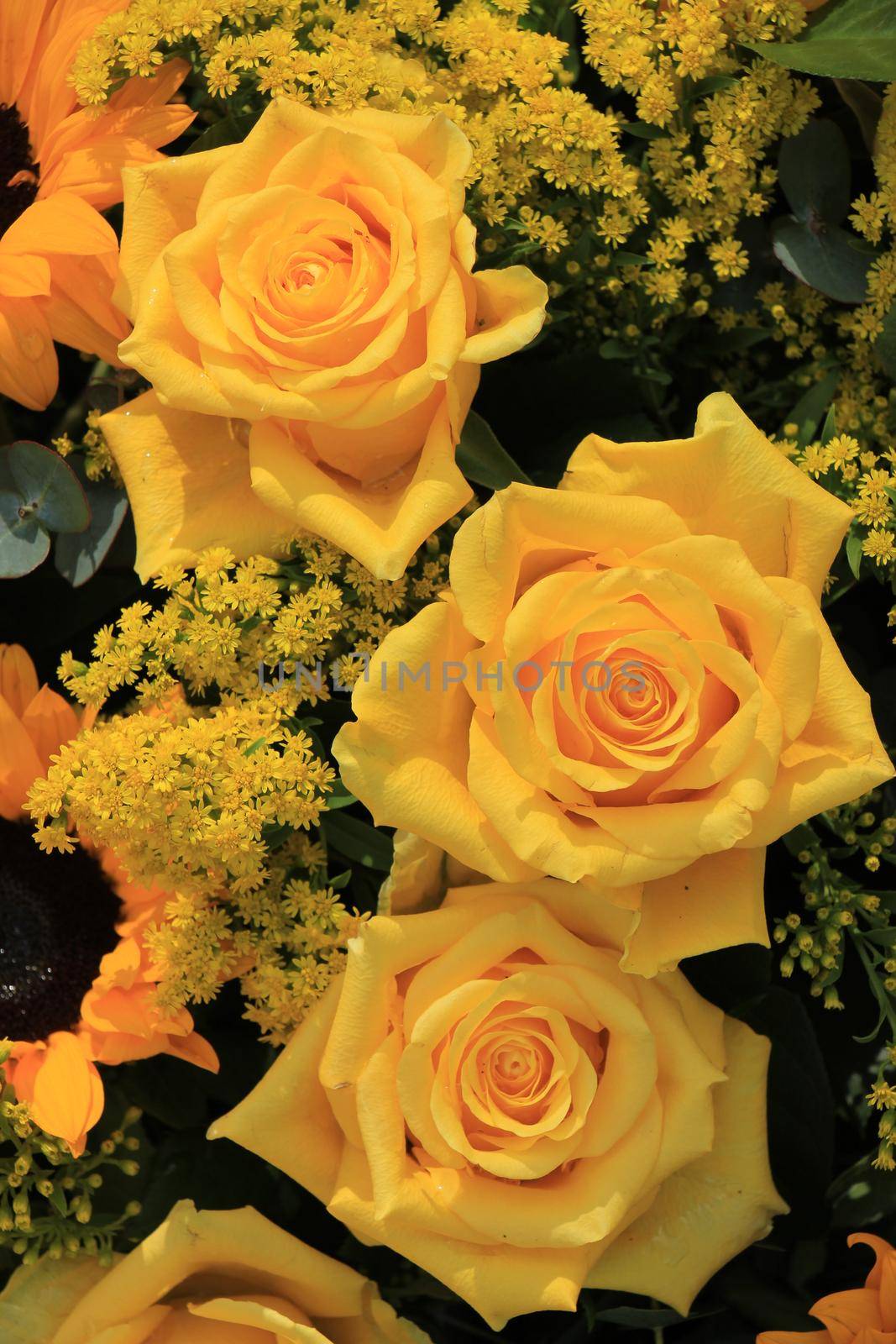 Mixed flower arrangement: various flowers in different shades of yellow for a wedding