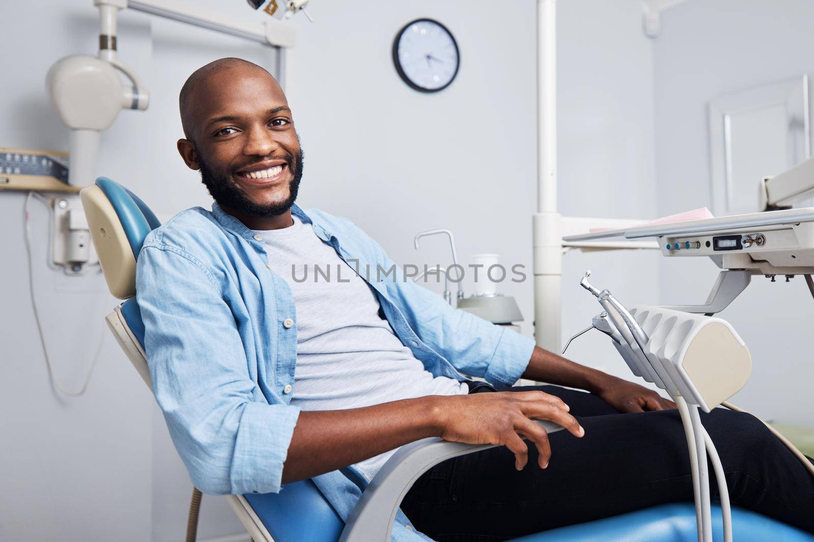 Im at the dentist It feels like a vacation. Portrait of a young man having dental work done on his teeth. by YuriArcurs