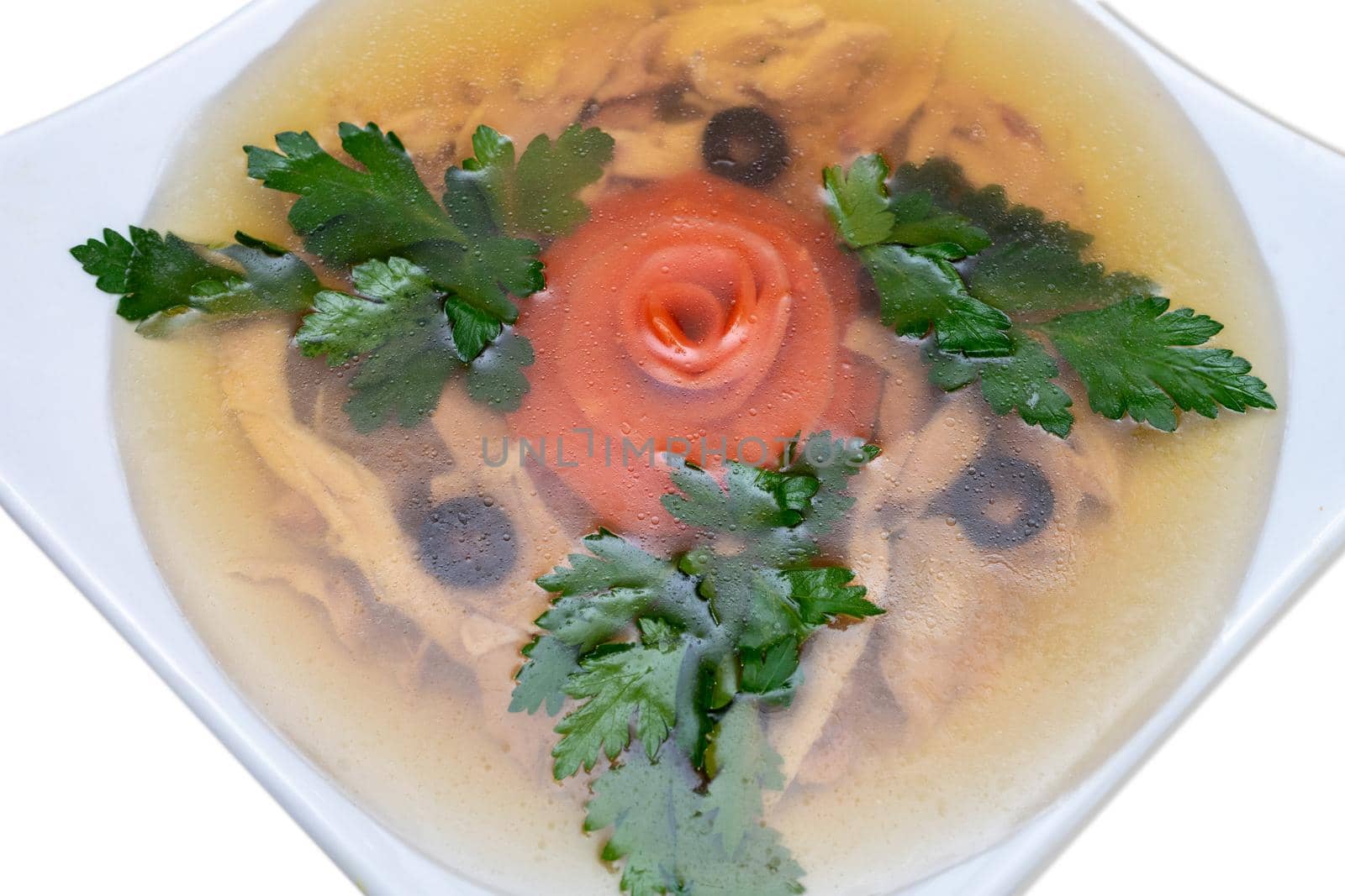 Chicken kholodets is decorated with parsley. Aspic jellied meat with vegetables, traditional food.