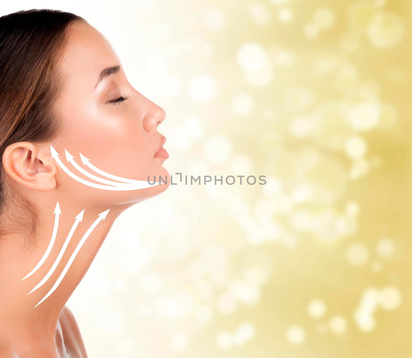 Portrait of woman with perfect skin and makeup, antiaging concept. golden blurred background.