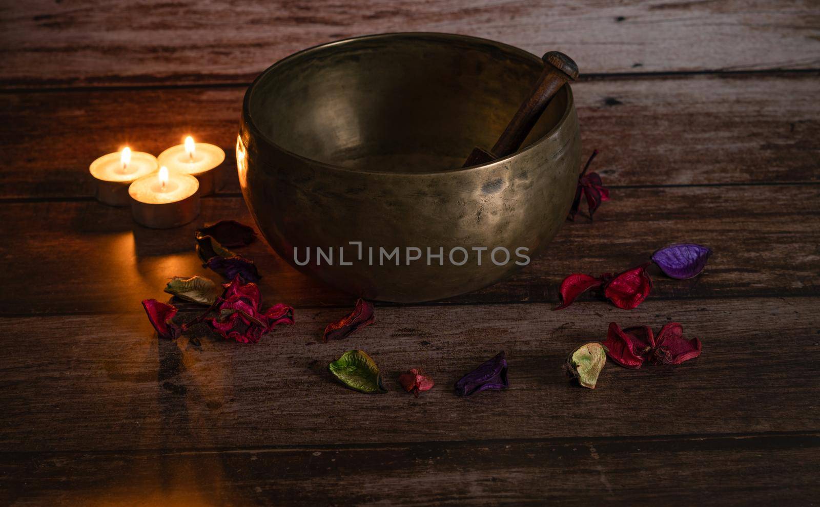 tibetan bowl with flower petals and candles by joseantona