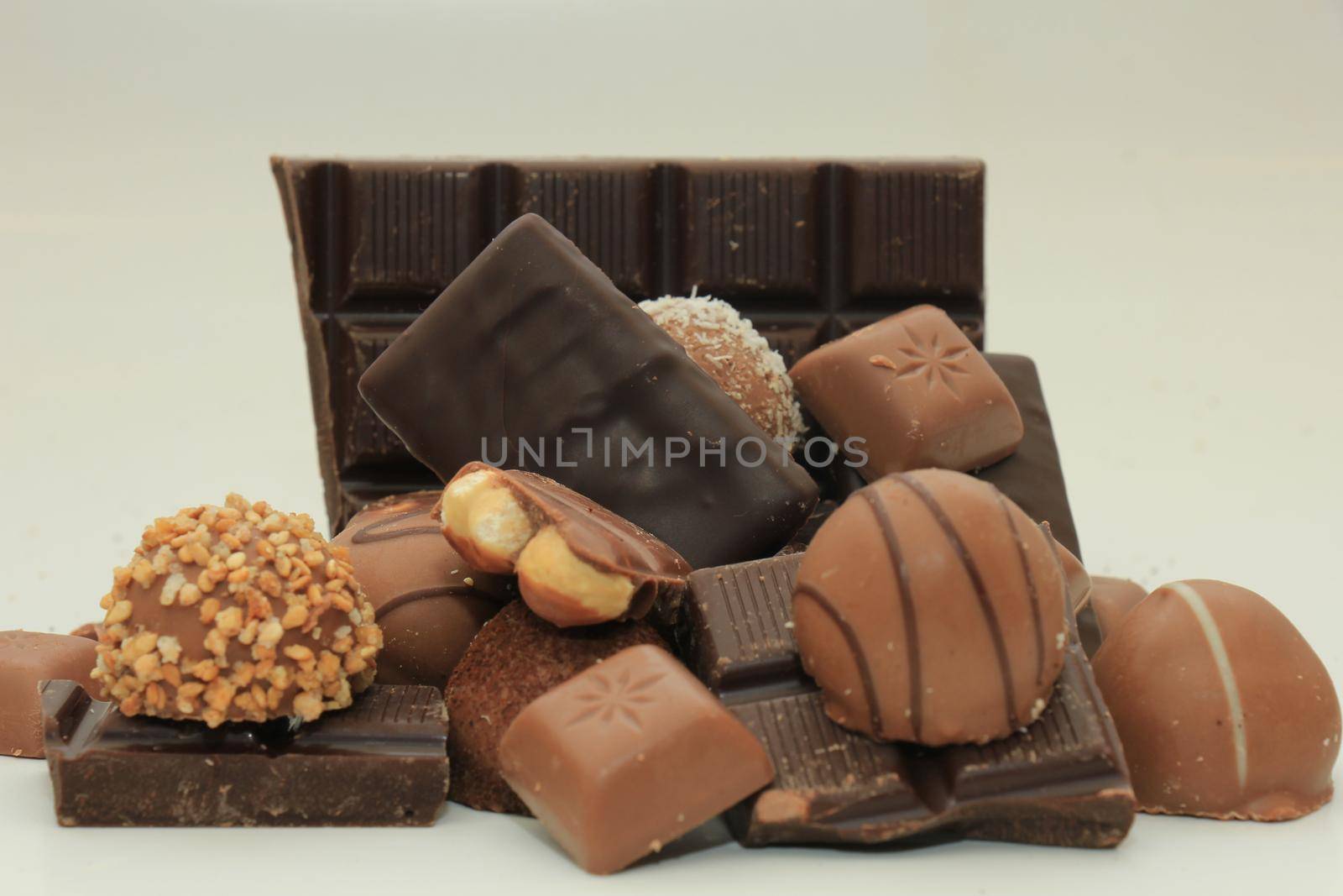 Different sorts of chocolates: bonbons and broken pieces of a chocolate bar