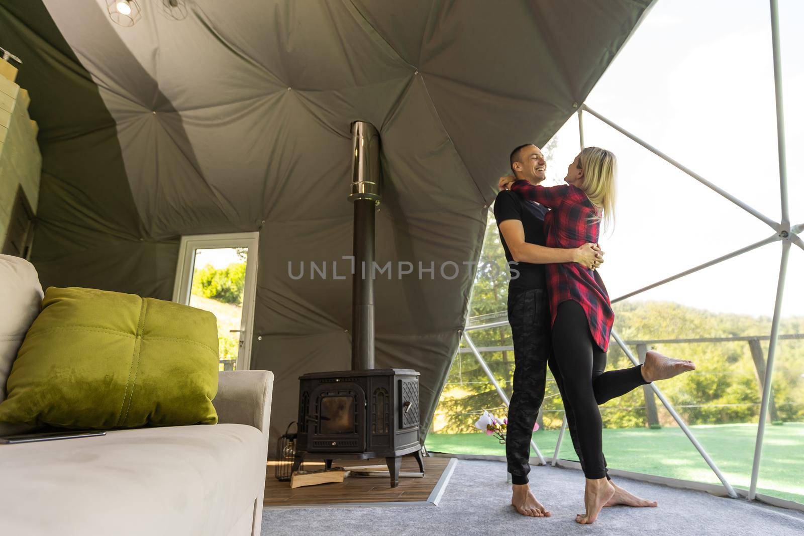 a couple in geo dome tents. Cozy, camping, glamping, holiday, vacation lifestyle concept. Outdoors cabin, scenic background