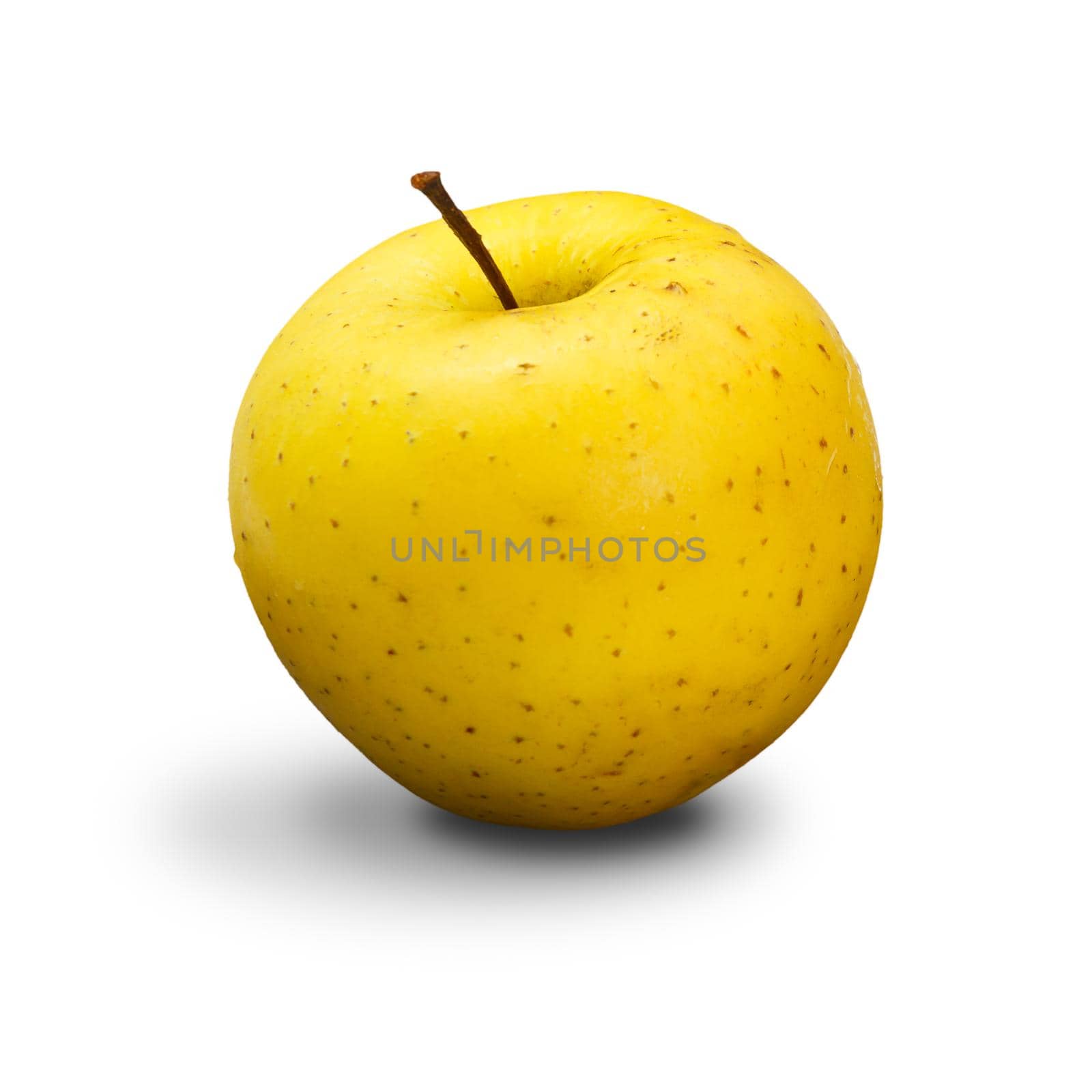 Mature yellow apple on the white isolated background. Organic fruits.
