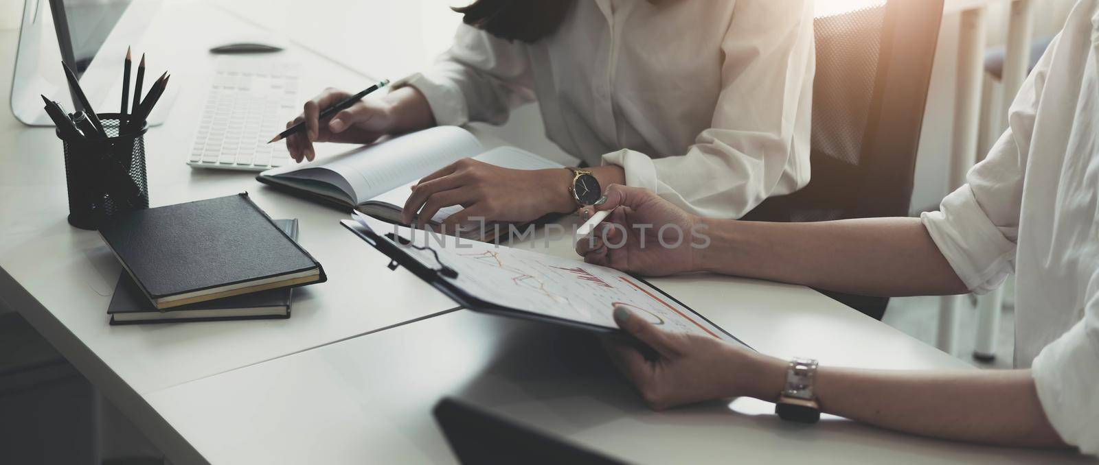 Close up Business woman and partner discussing about target or planning of company, tax, accounting, statistics and analytic research, group support and meeting concept by wichayada