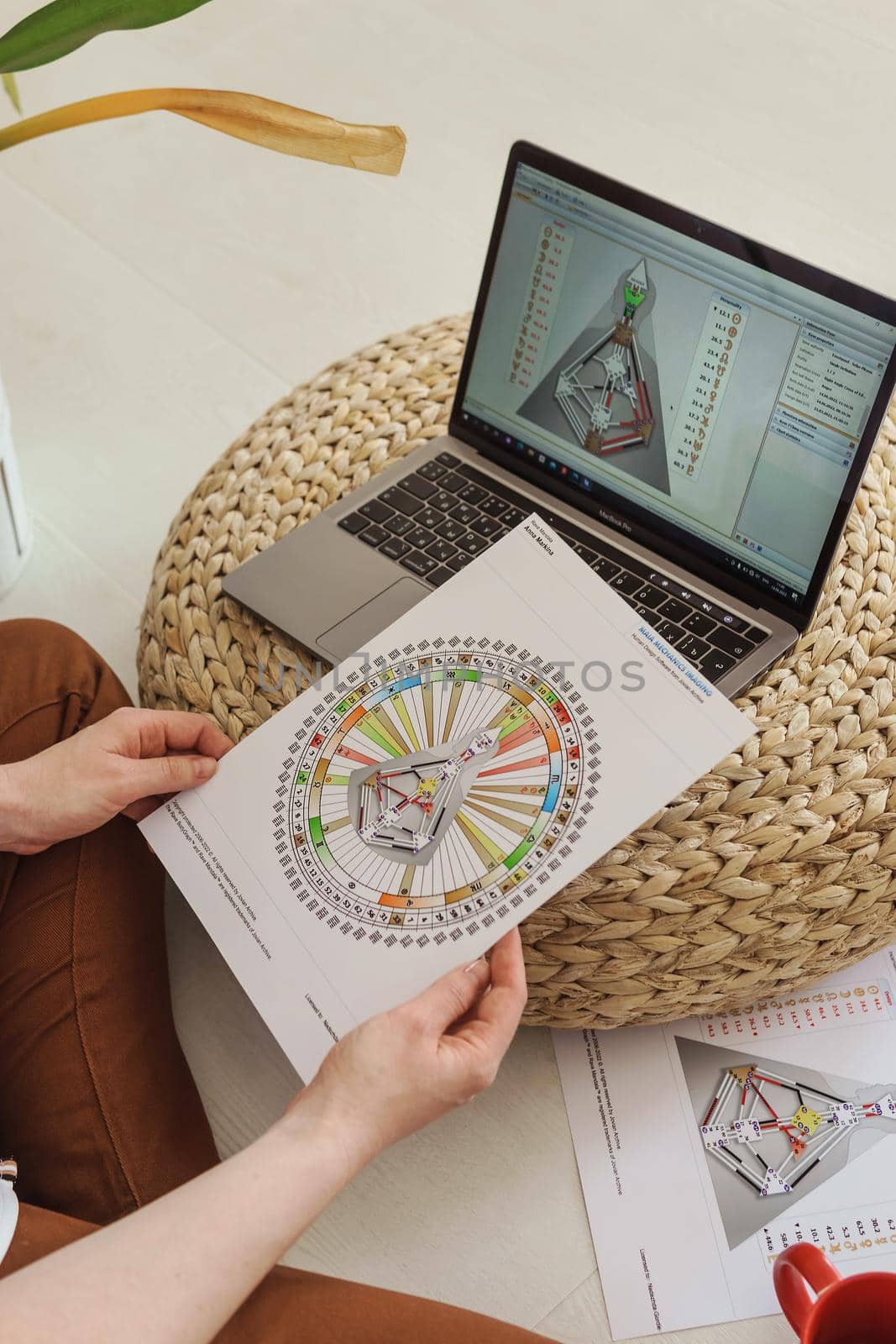 Tver, Russia-august 7, 2022. A woman with a laptop is studying human design. The concept of studying esoteric sciences. Studying rave postcards from human design. by Annu1tochka