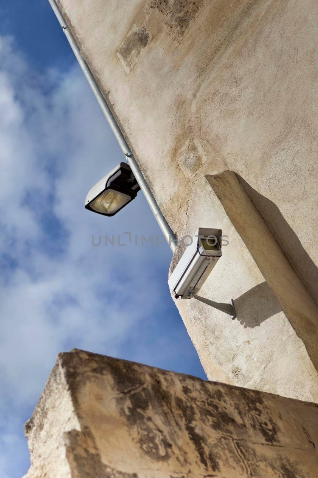 Outdoor street light and security camera on a building