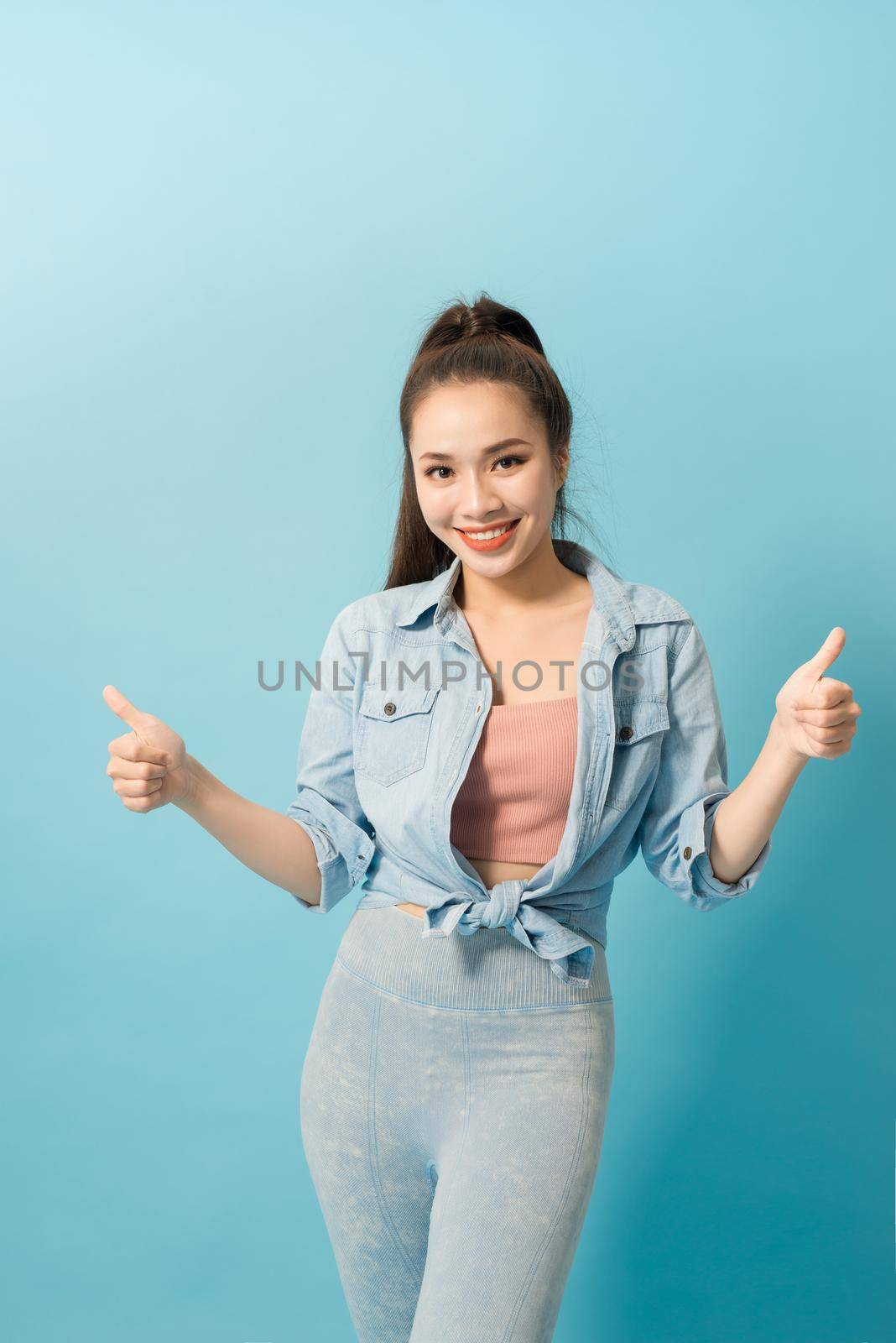 Active young woman in casual summer outfit having fun indoor.