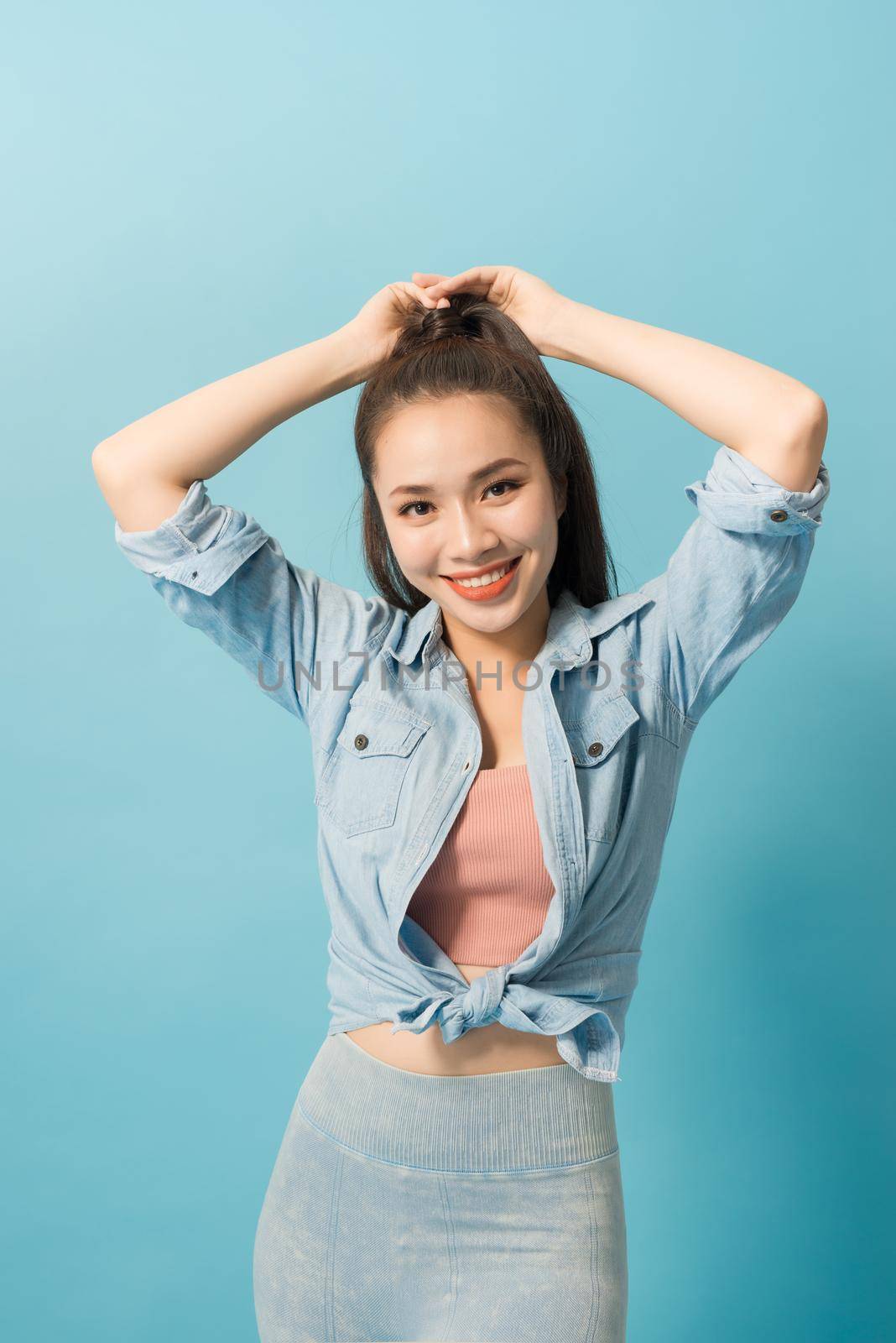 Active young woman in casual summer outfit having fun indoor.