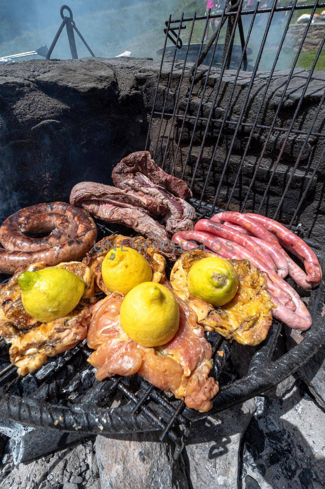 Typical Uruguayan and Argentine Asado Cooked on fire. Entrana and Vacio meat cuts. Accompanied with Chorizo
 by martinscphoto