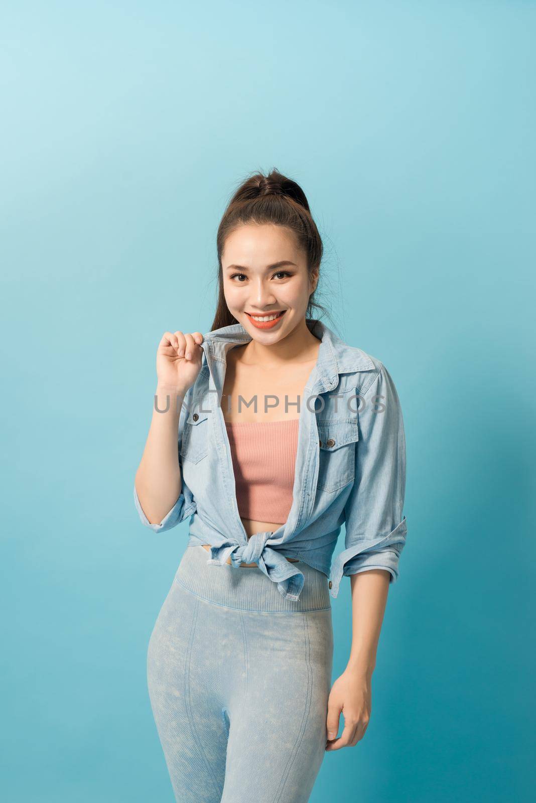 Active young woman in casual summer outfit having fun indoor.