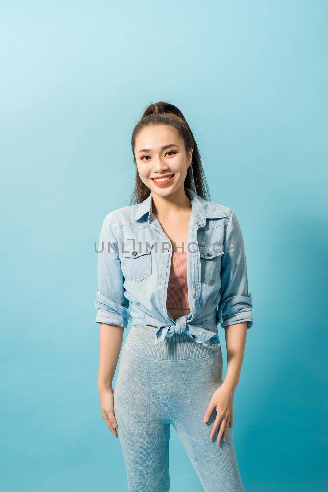 Active young woman in casual summer outfit having fun indoor.