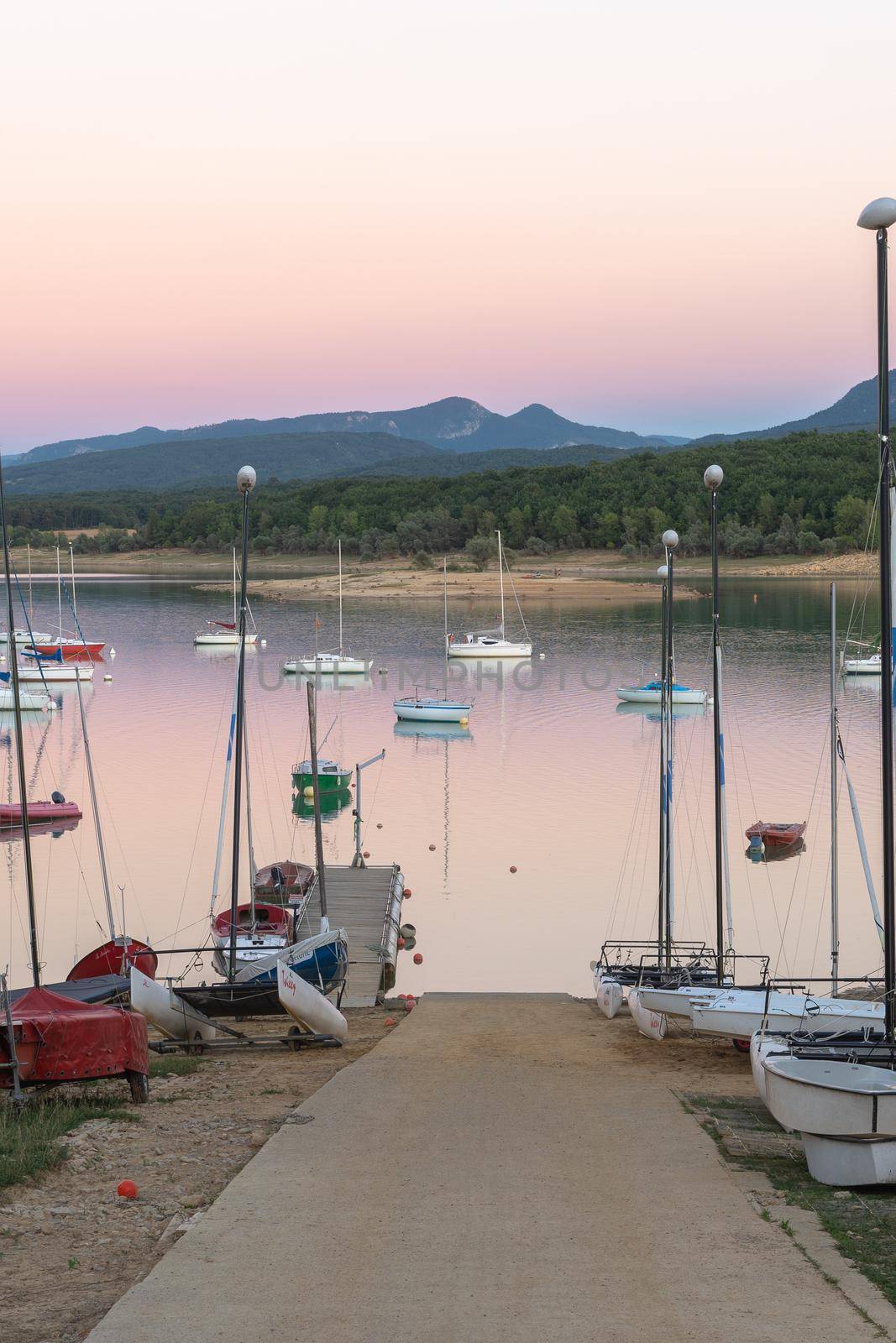 Sunset on Lake Montbel in Ariege with the boats in the summer of 2022. by martinscphoto