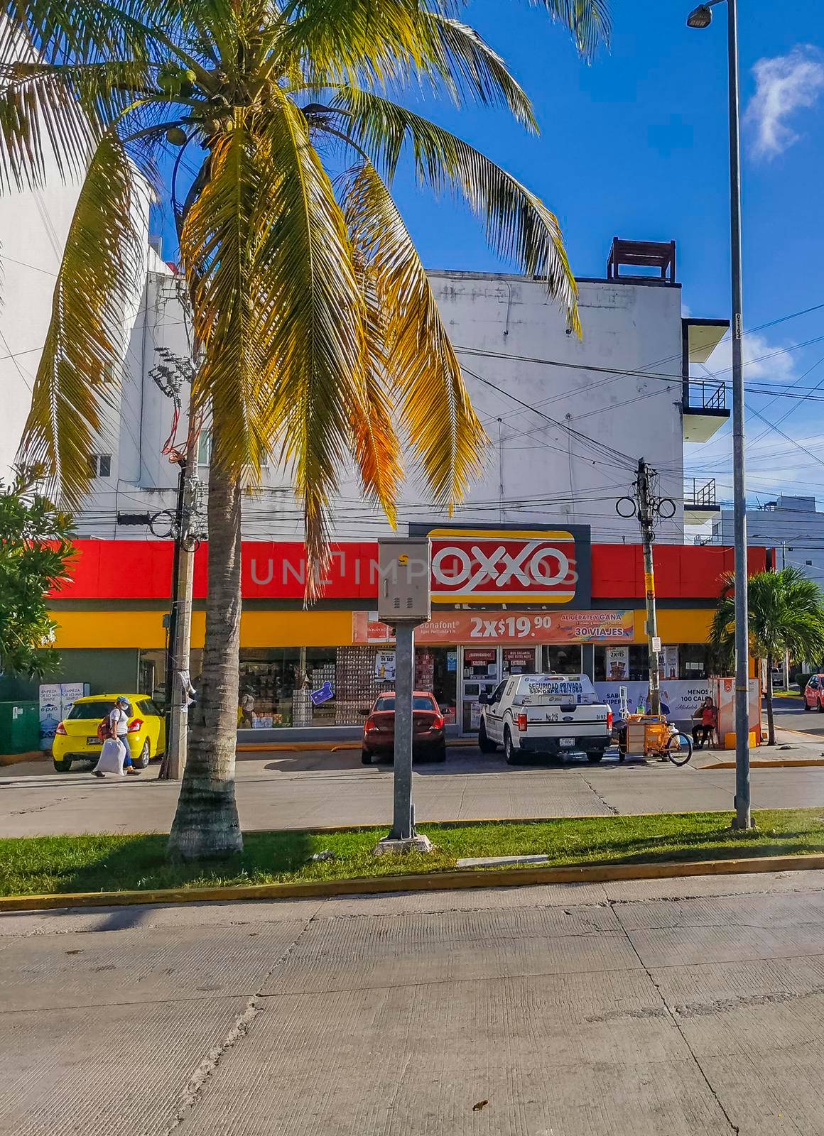 Playa del Carmen Mexico 04. July 2022 Typical street road and cityscape with cars and buildings of Luis Donaldo Colosio Playa del Carmen in Mexico.