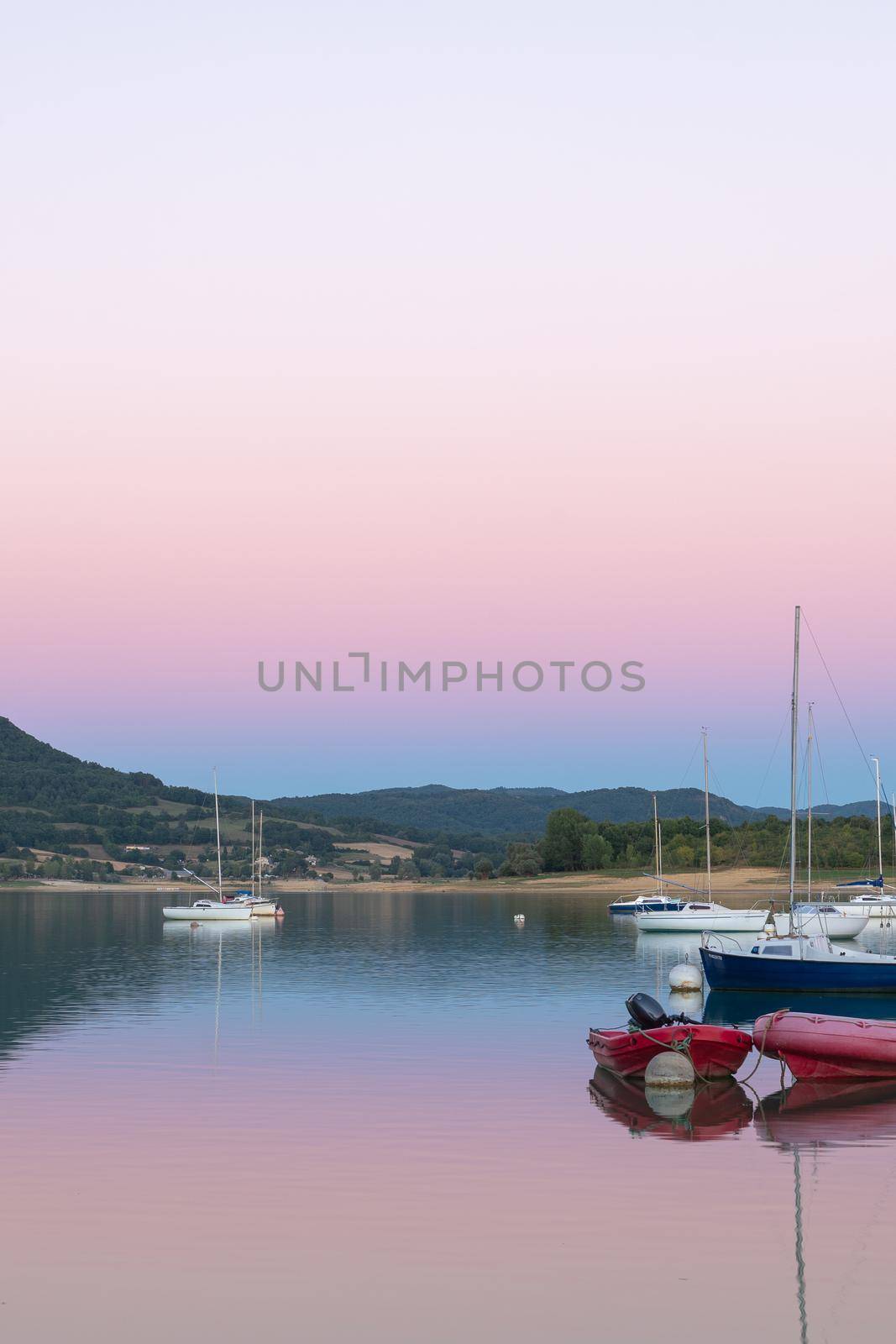 Montbel, France. 2022 August 2 . Sunset on Lake Montbel in Ariege with the boats in the summer of 2022.