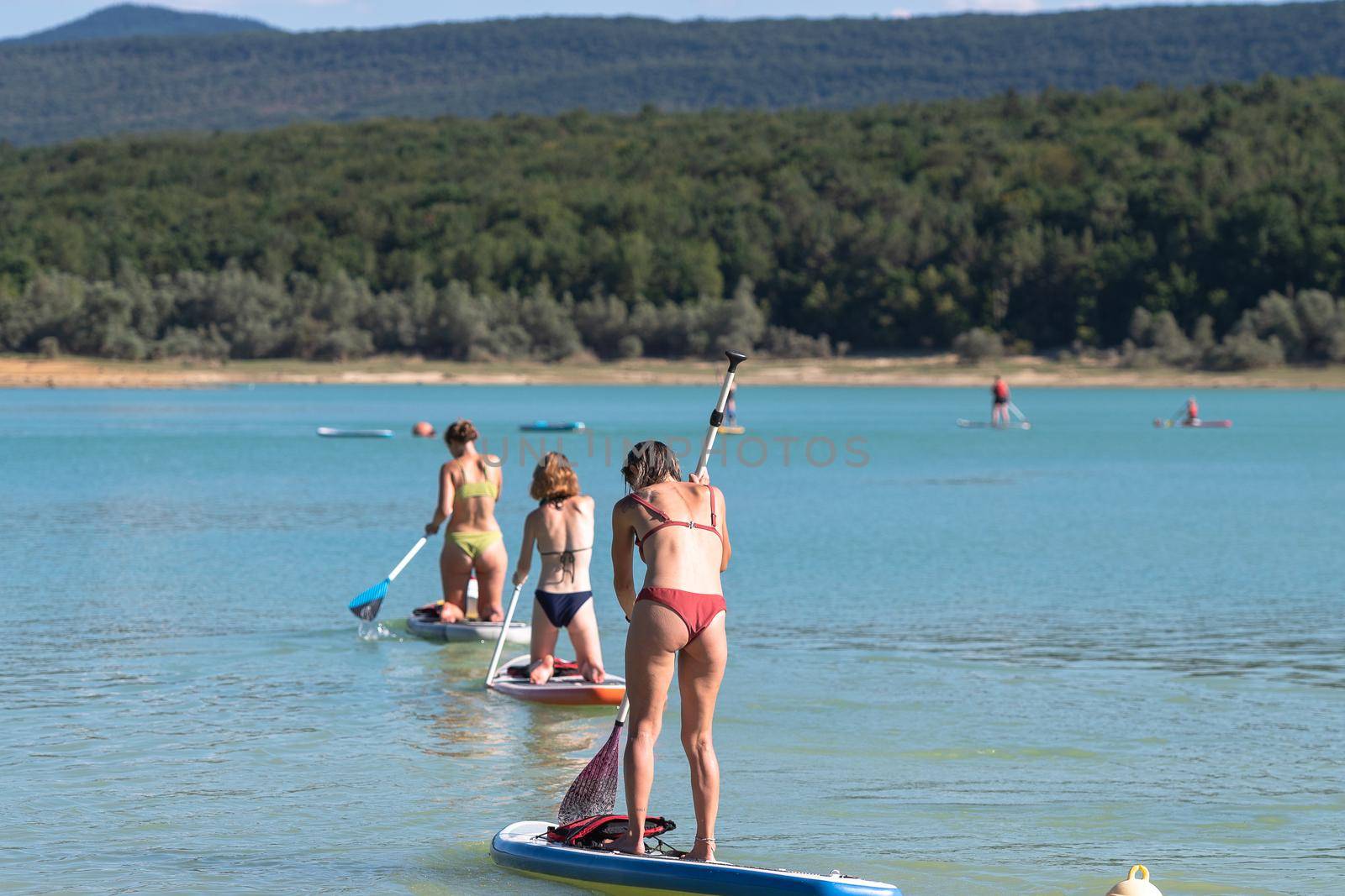 Montbel, France. 2022 August 2 . People practicing water sports on Lake Montbel in Ariege with the boats in the summer of 2022.