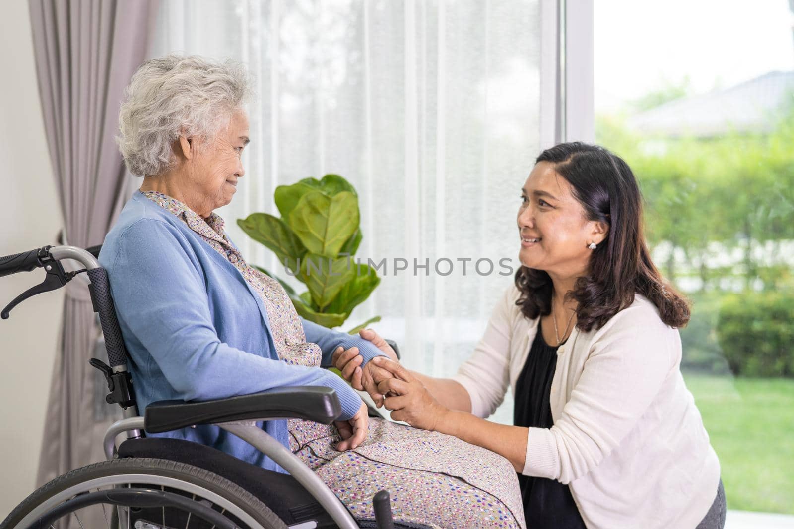 Caregiver daughter help Asian senior or elderly old lady woman sitting on wheelchair and wearing a face mask for protect safety infection Covid-19 Coronavirus.