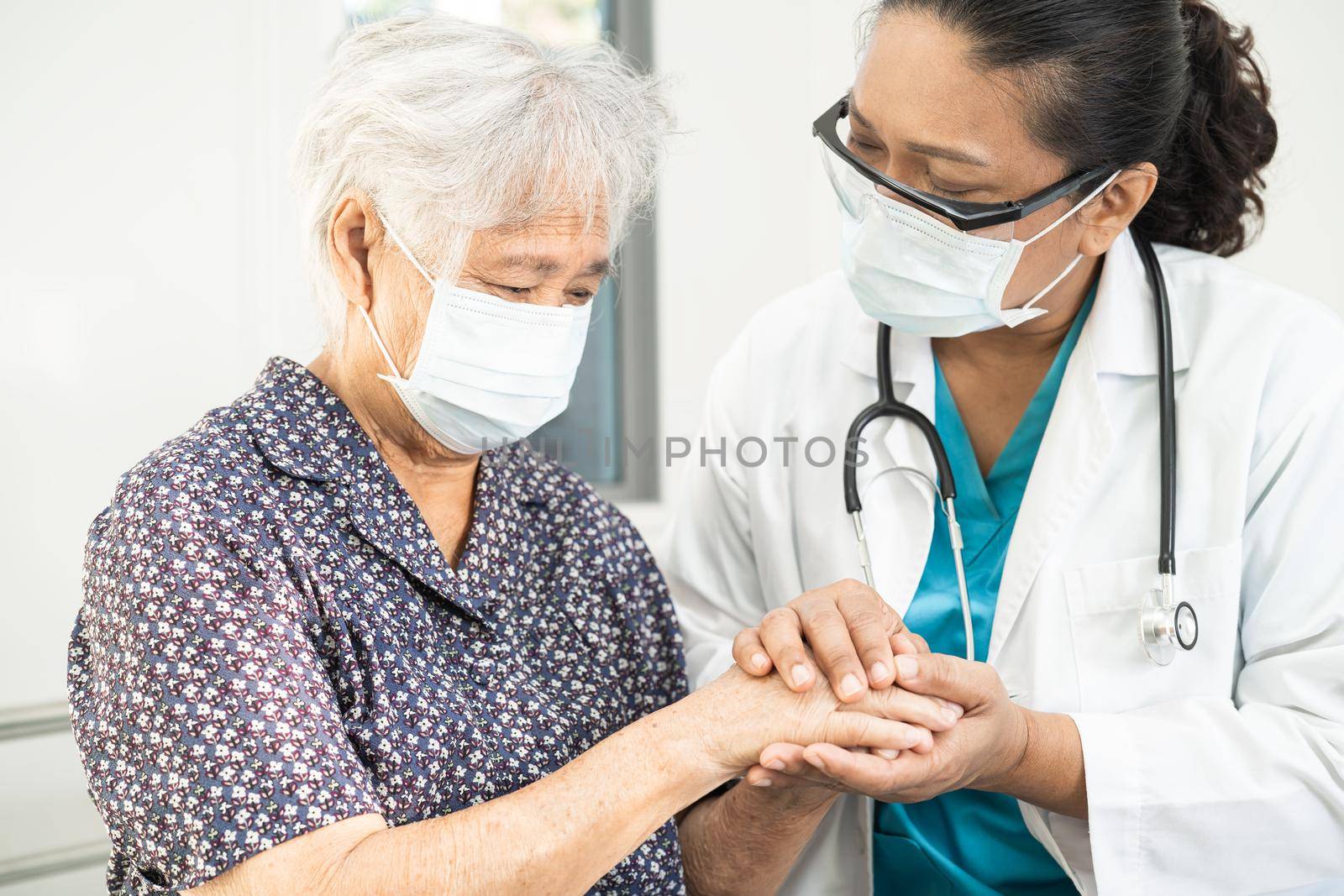 Holding hands Asian senior or elderly old lady woman patient with love, care, encourage and empathy at nursing hospital ward, healthy strong medical concept by pamai