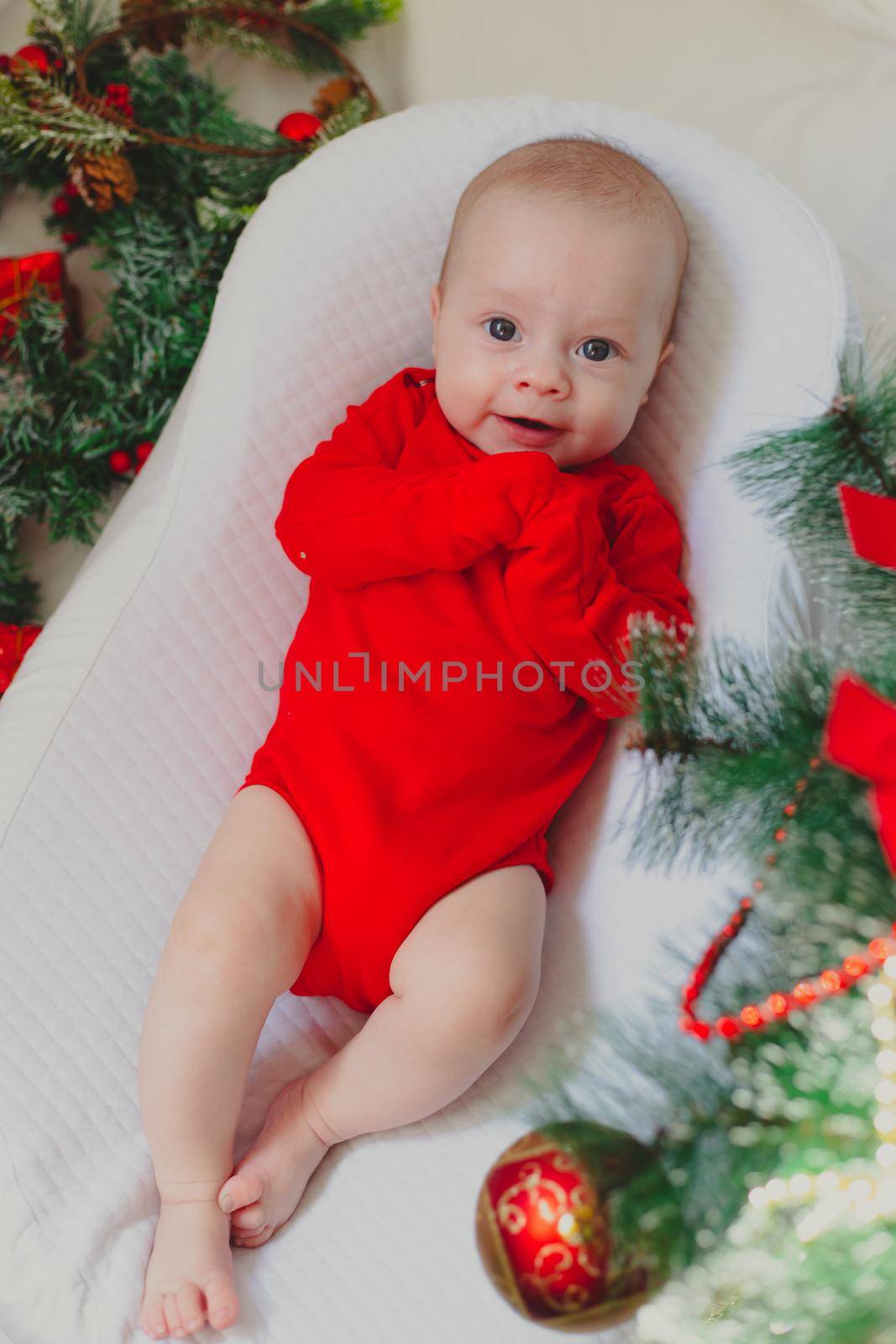 Baby in a cocoon new year . An article about the new year. An article about children. The first new year of the baby. Red bodysuit. by alenka2194