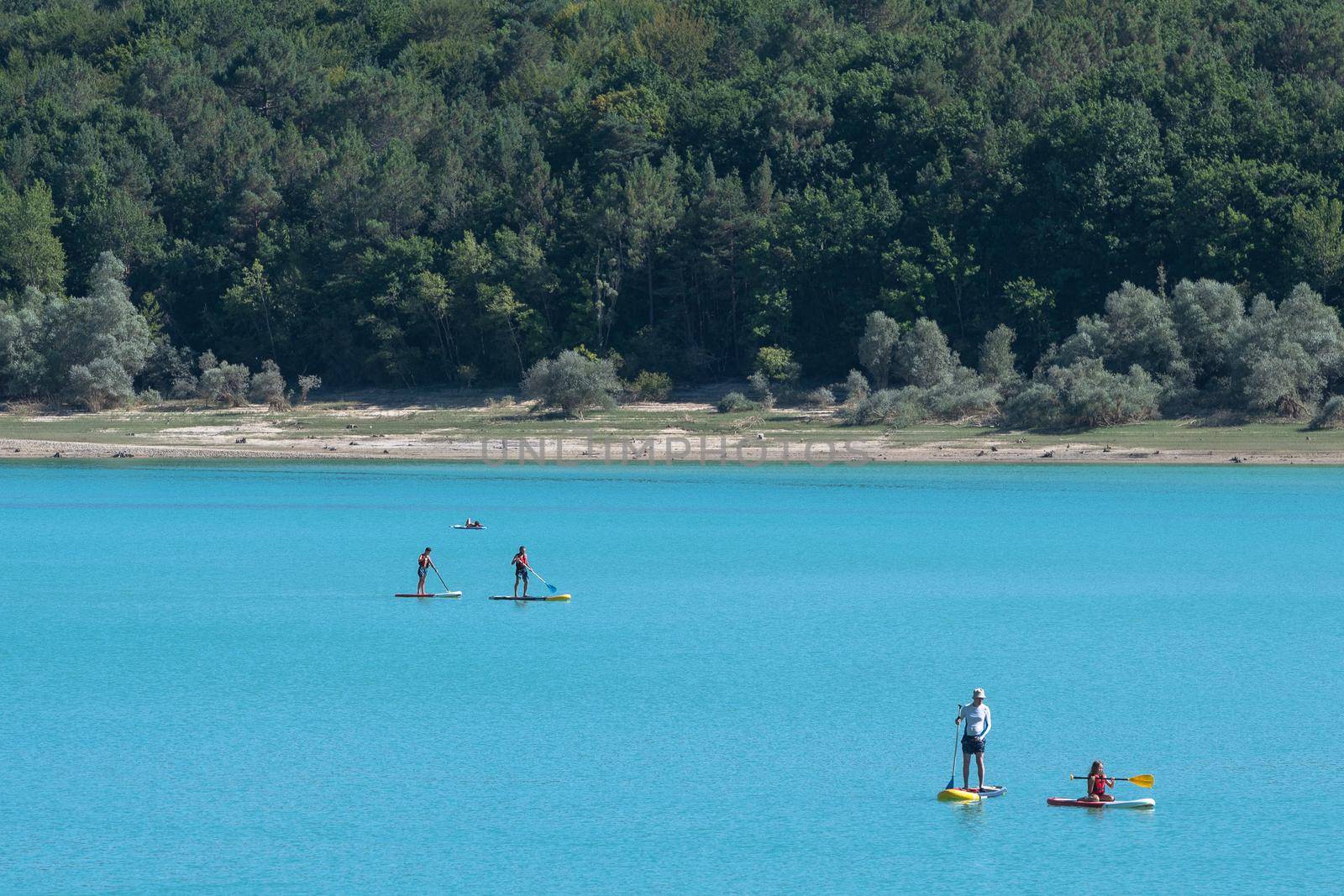 Montbel, France. 2022 August 2 . People practicing water sports on Lake Montbel in Ariege with the boats in the summer of 2022.