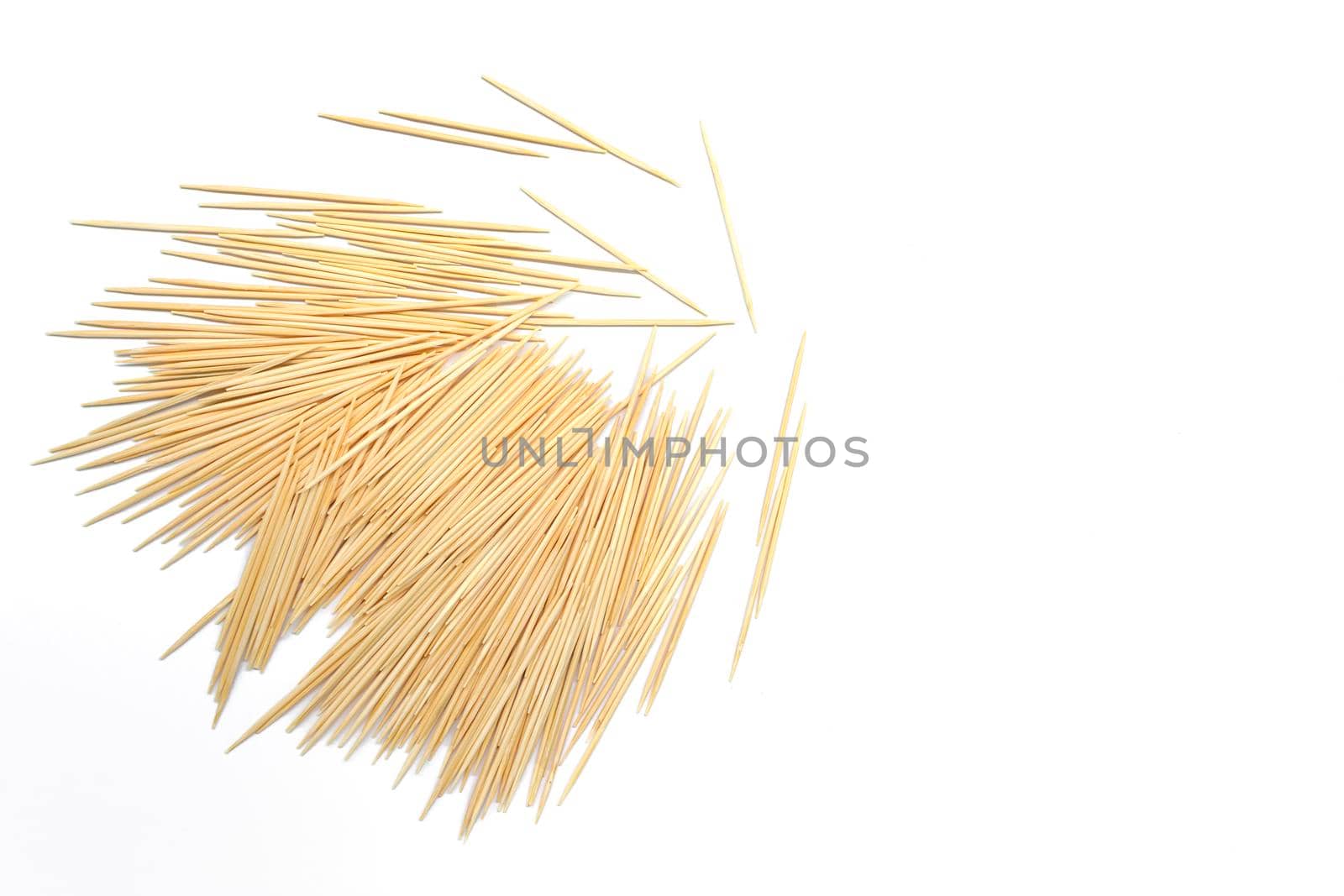 Pile of wooden toothpicks on white background. Copy space. Directly above. Flat lay.