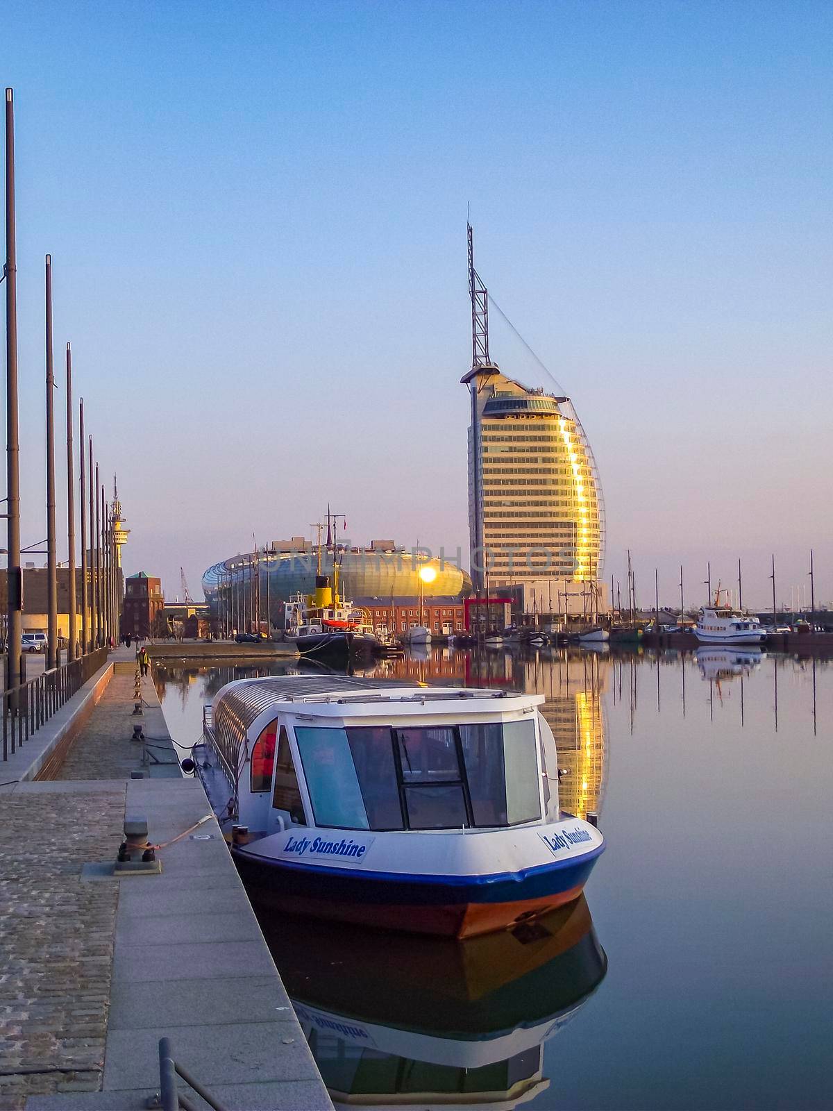 Cityscape sunset coast boats and dike panorama Bremerhaven Germany. by Arkadij