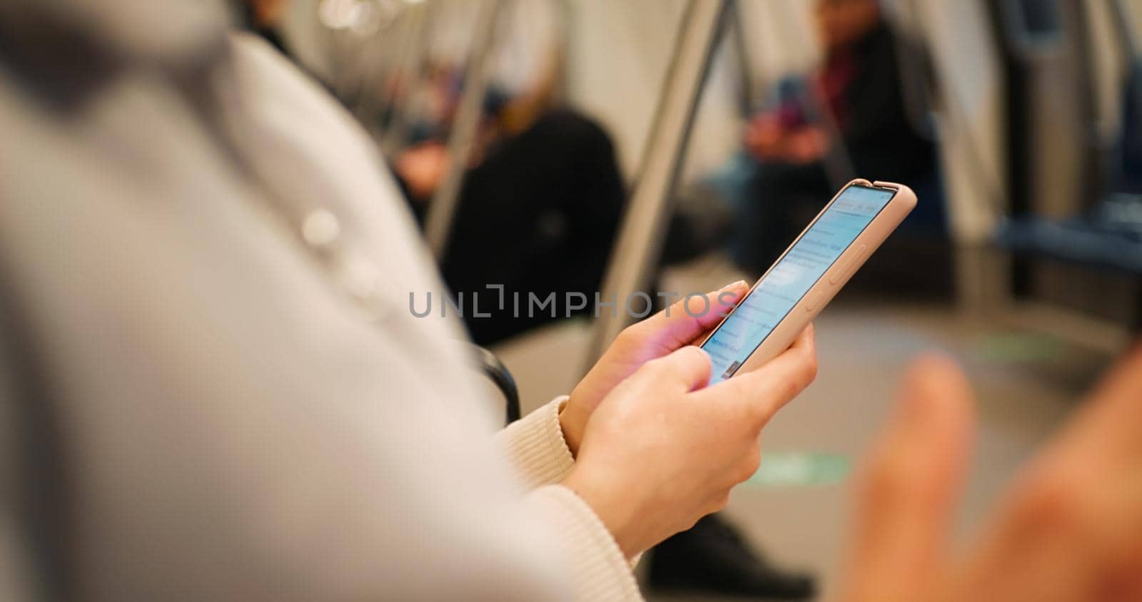 Woman hands using smartphone on subway, Close Up. Female in subway searching internet, using app, reading, learning online or texting on cellphone. Technology in life.