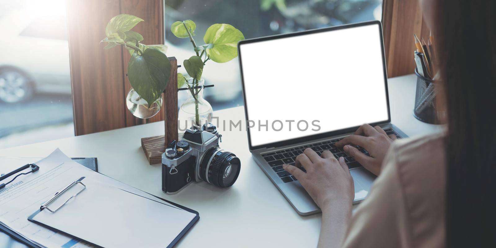 Young woman working with mockup laptop computer. by wichayada