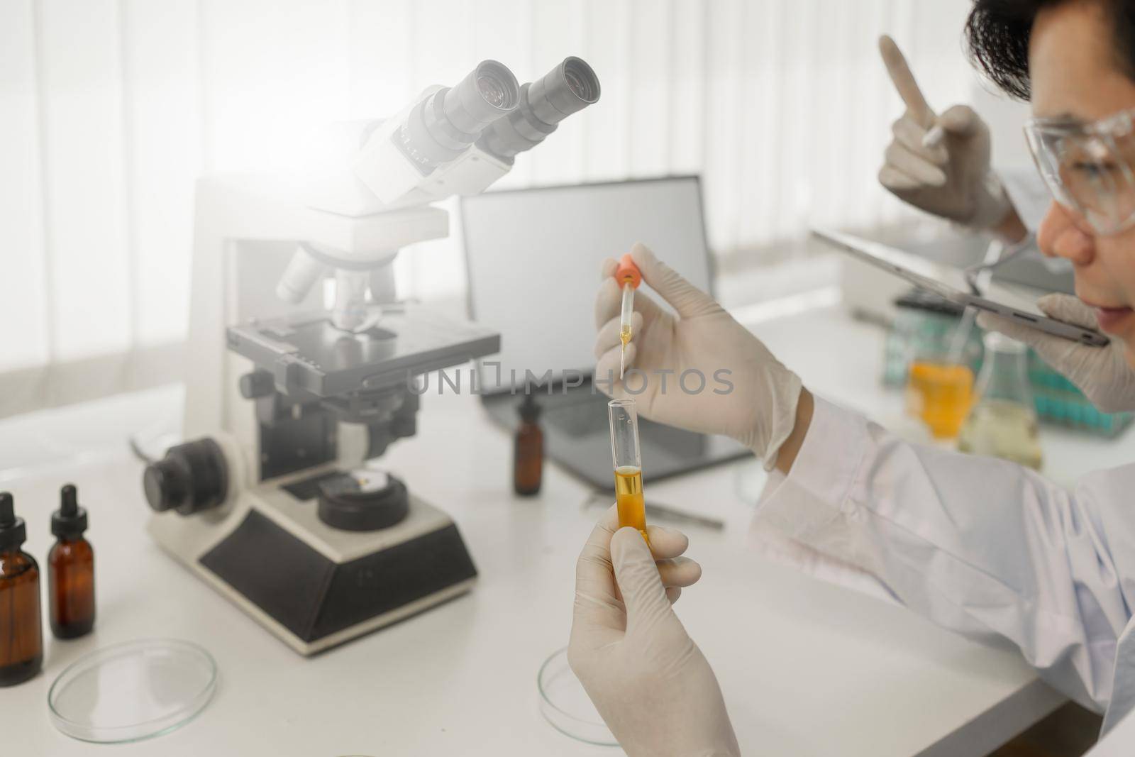 Scientist holding a test tube containing cannabis extract.