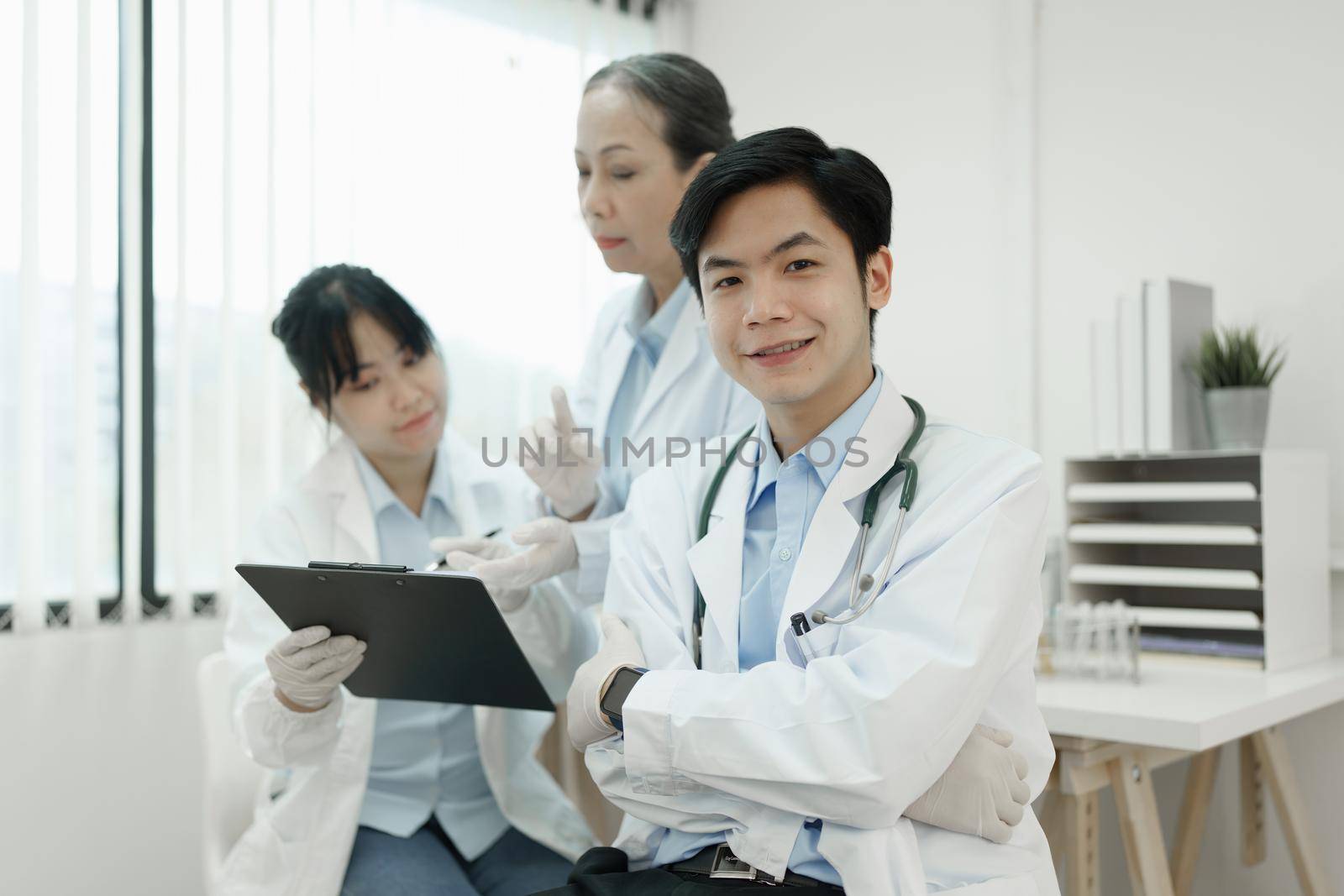 Group of science researchers analysing together at medical science laboratory.