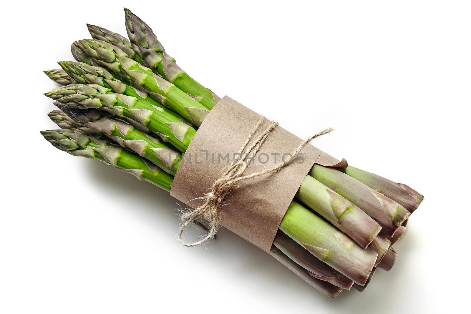 Bunch of an edible, ripe spears of asparagus isolated on white background. Fresh, green vegetables, top view. Healthy eating. Spring harvest, agricultural farming concept.