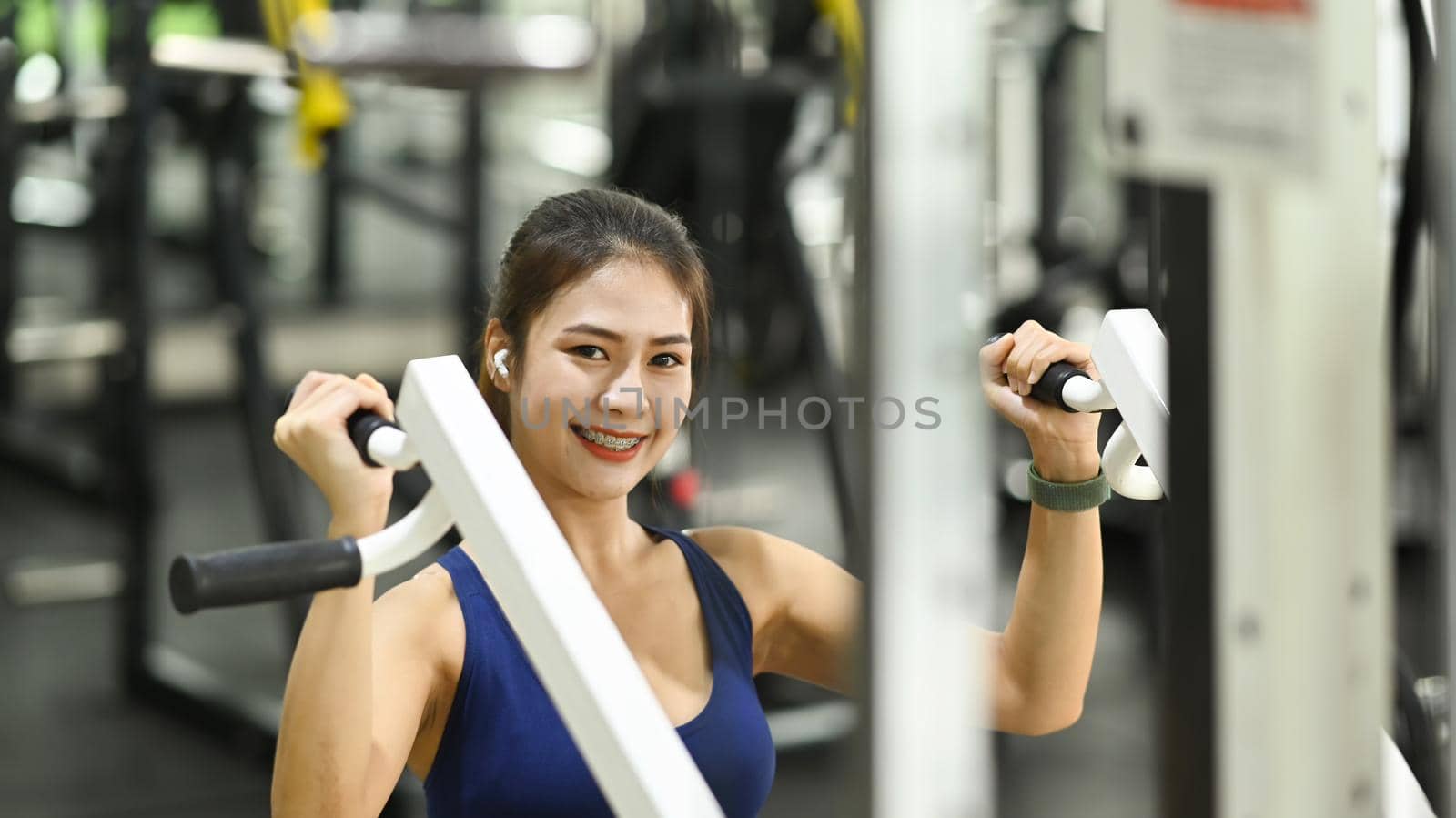 Fitness women in sportswear exercising at the gym. by prathanchorruangsak