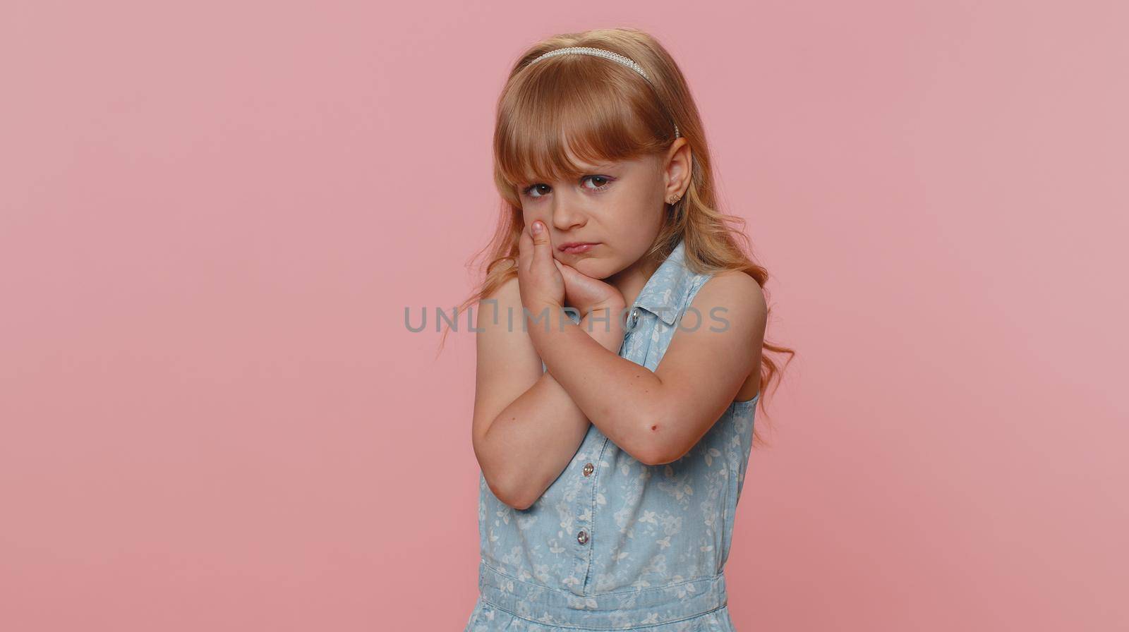 Young child girl kid touching cheek terrible suffer from painful toothache, sensitive teeth cavities by efuror