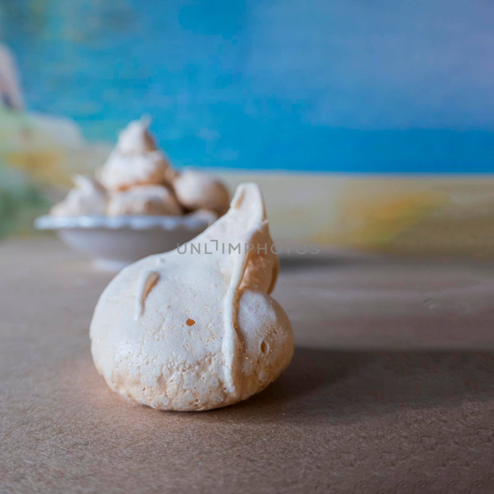 Homemade french milk-colored meringues on crumpled craft paper. delicious homemade meringues on craft paper