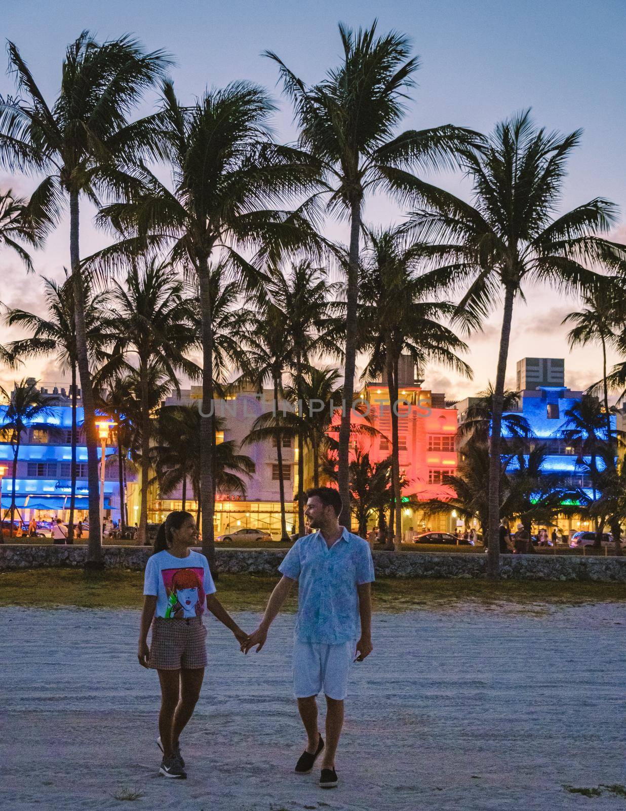 Miami Beach April 2019, colorful Art Deco District at night. Miami Beach Ocean Drive hotels and restaurants at sunset. City skyline with palm trees at night. Art deco nightlife on South beach