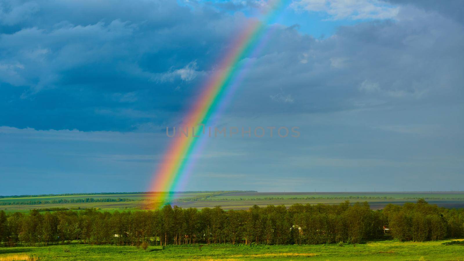 The Rainbow over Rural Landscape after Thunderstorm. by sarymsakov