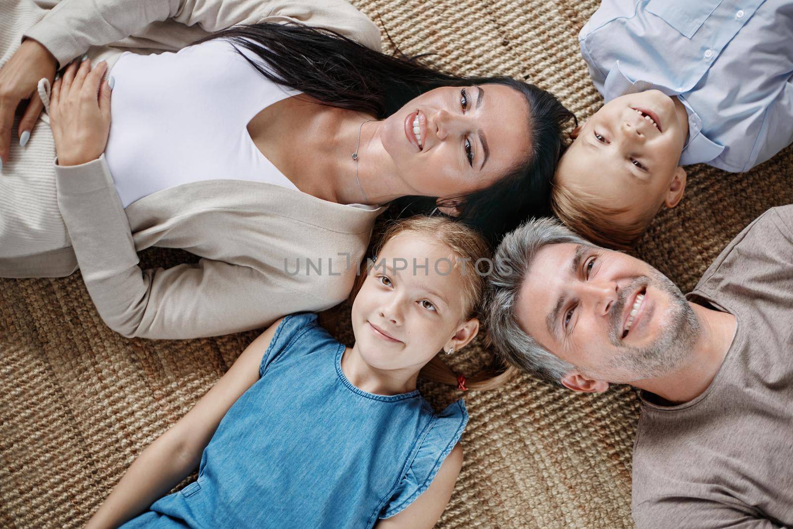 happy family with two children lying on the floor. top view.