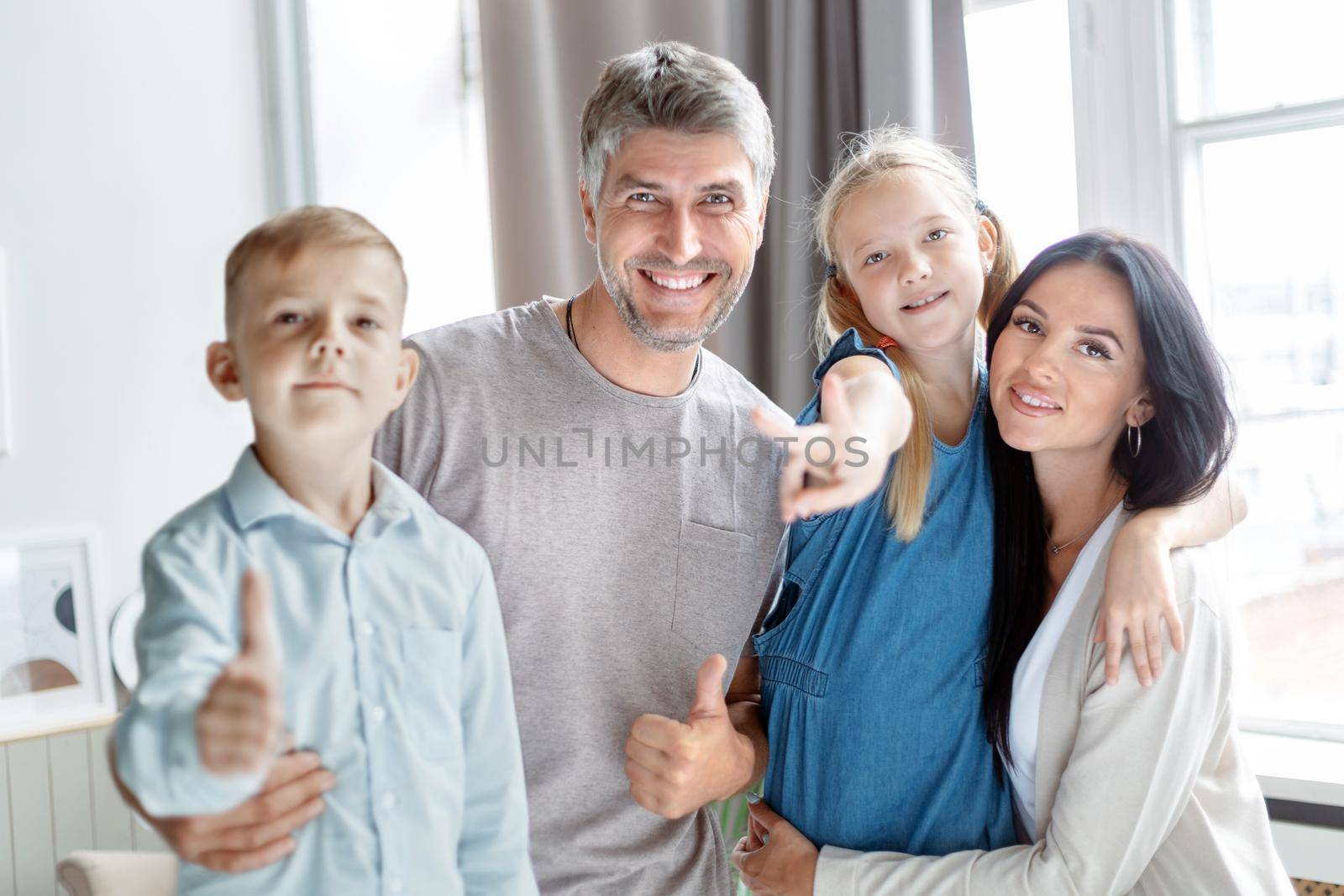 portrait of a happy family near the window. by SmartPhotoLab