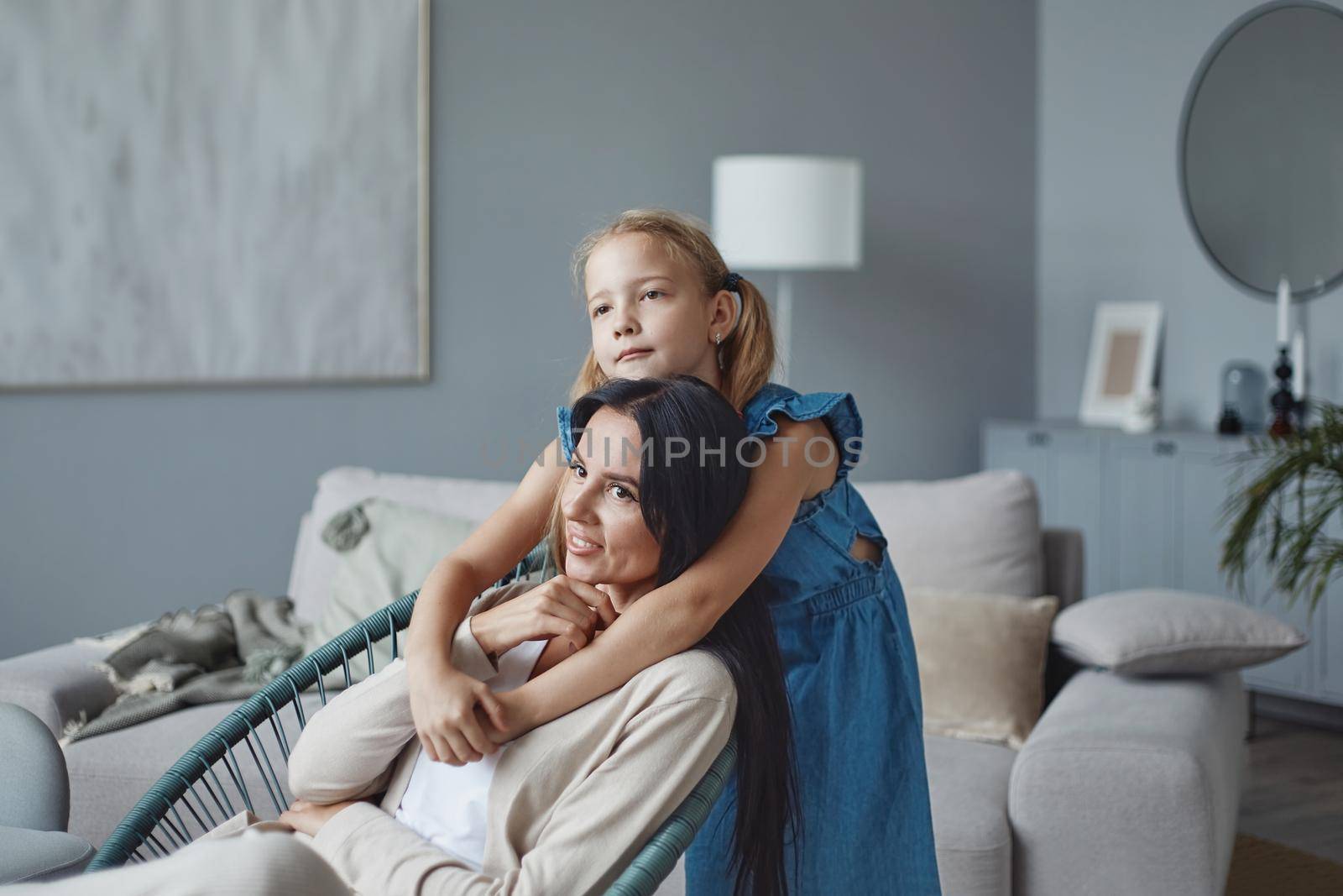 pretty little girl gently hugging her mom. by SmartPhotoLab