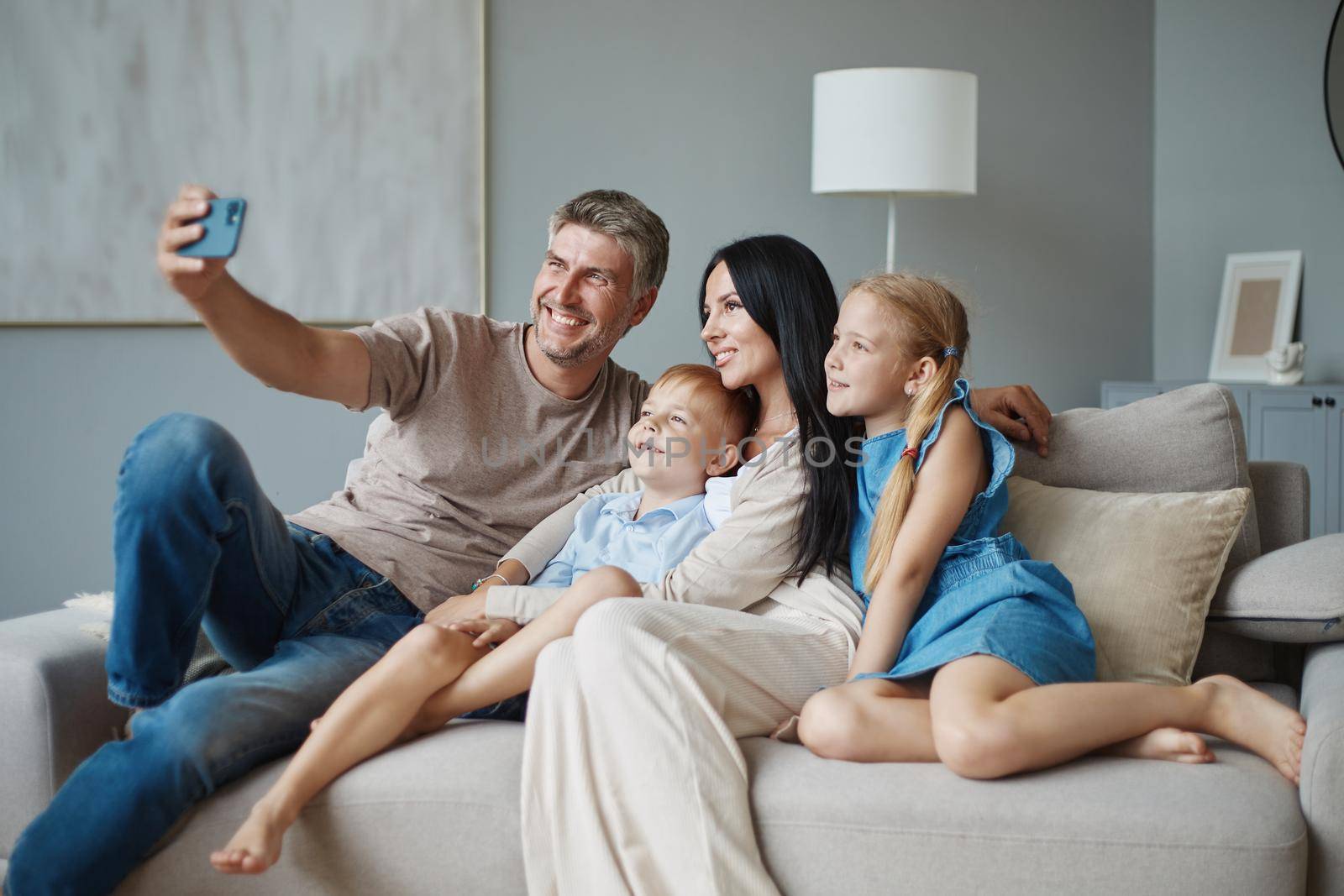happy family taking a selfie in their living room. a photo with a copy -space.