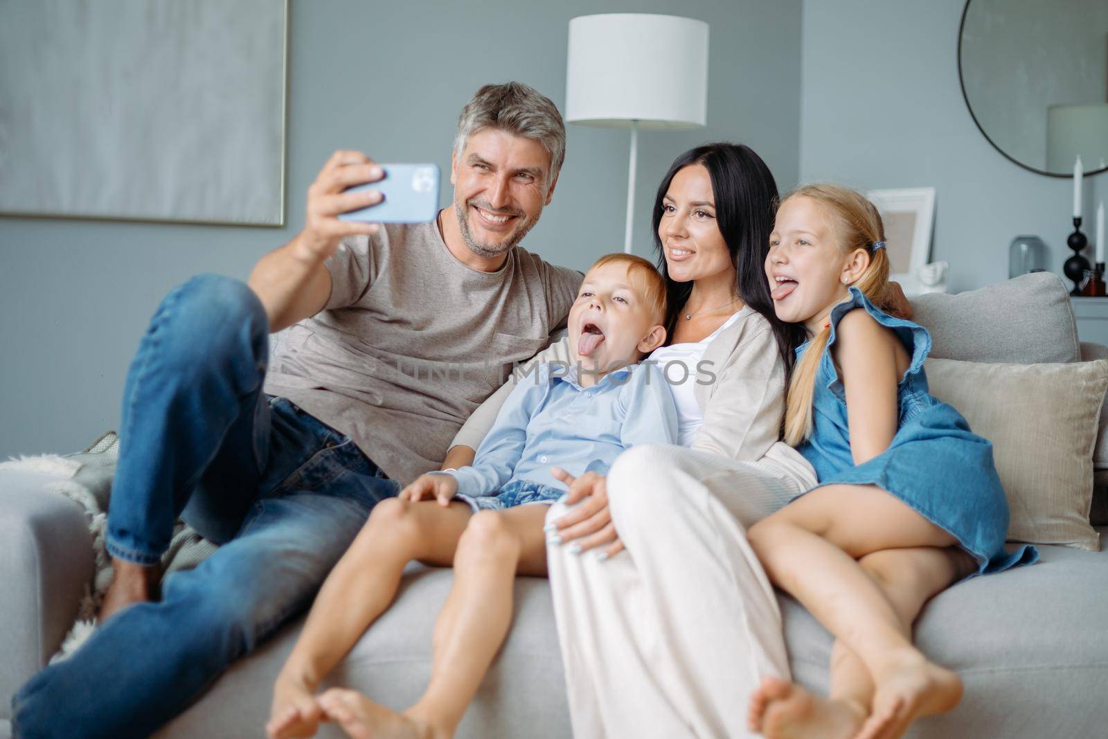 happy family with kids having fun taking selfies sitting on the couch. close-up.