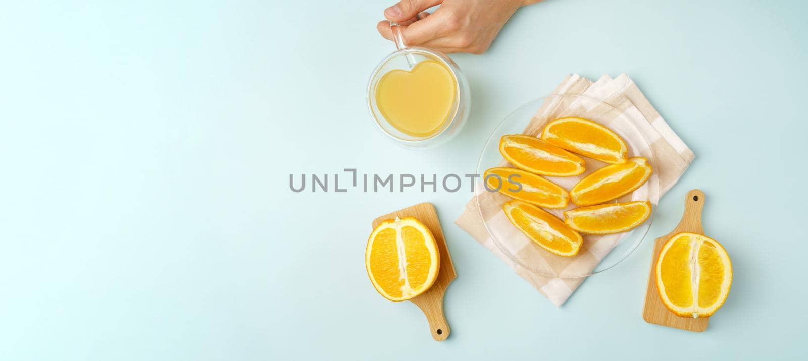 Orange juice in the glass. Healthy drink on a blue background. View from above. Love for fruits, healthy food. Copy space
