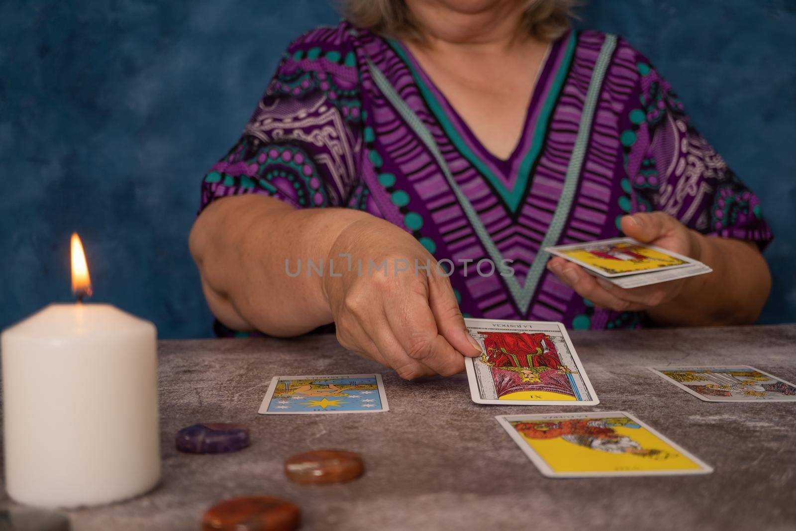 woman casting tarot cards by joseantona